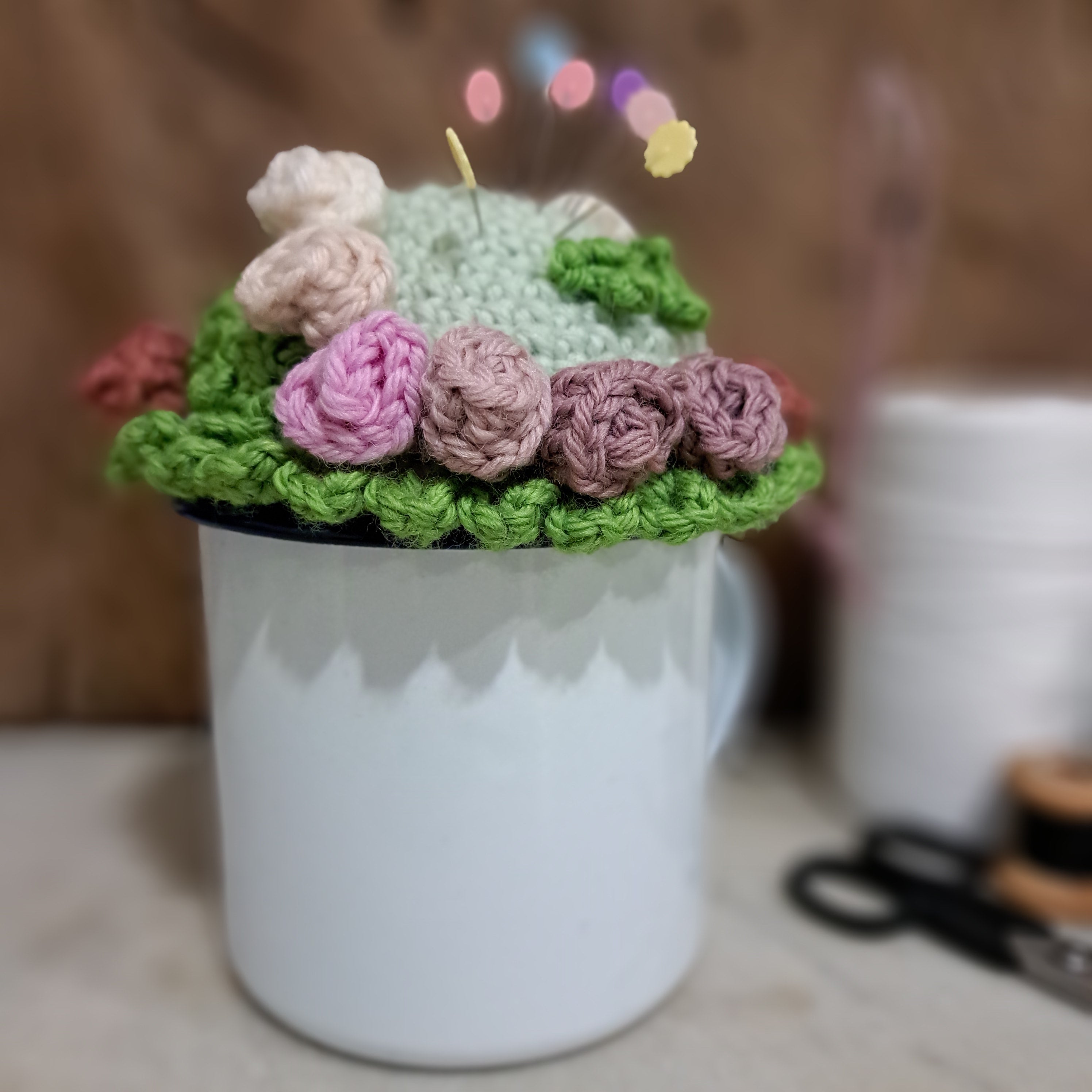 Crochet pin cushion with pretty roses in a sturdy enamel tin mug