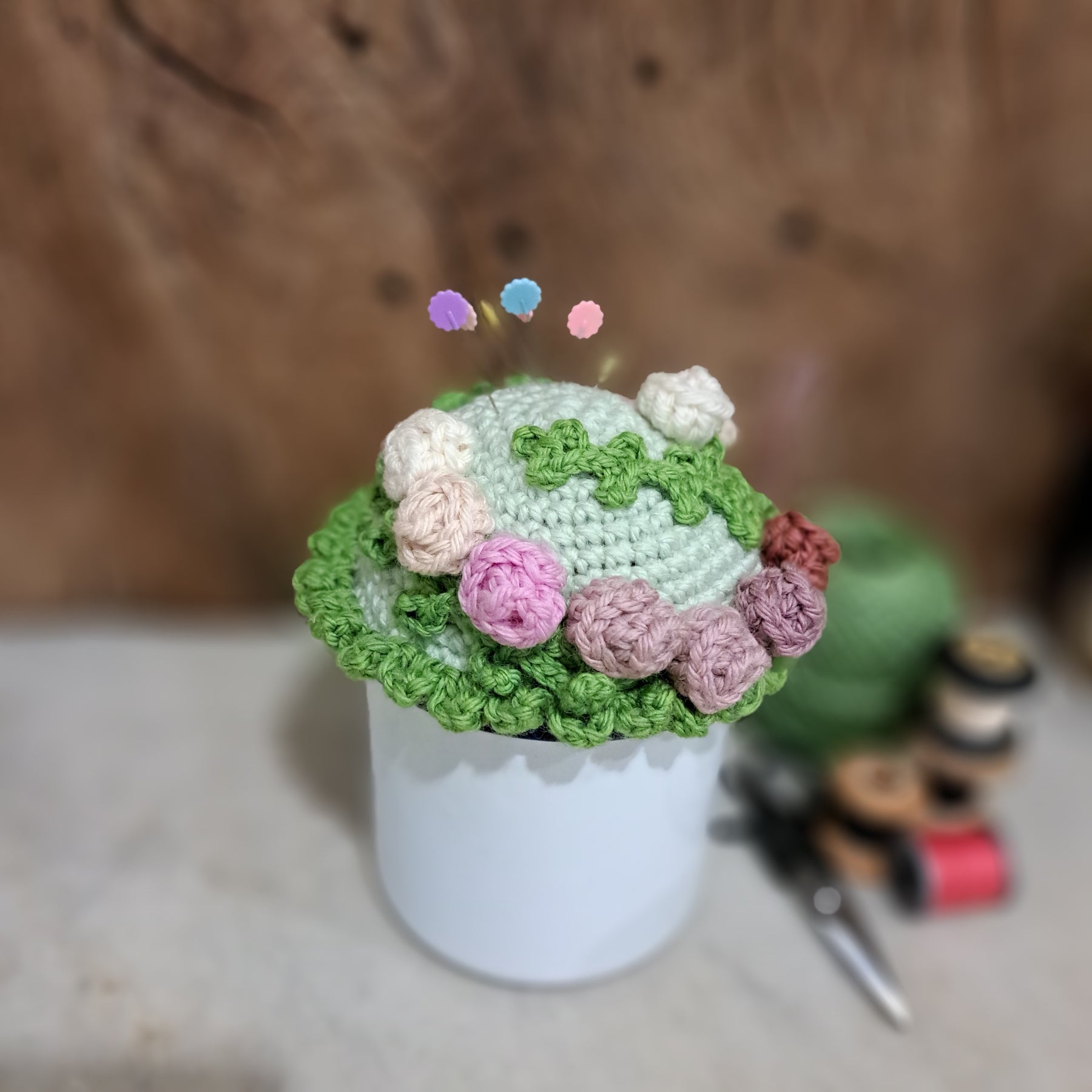 Crochet pin cushion with pretty roses in a sturdy enamel tin mug