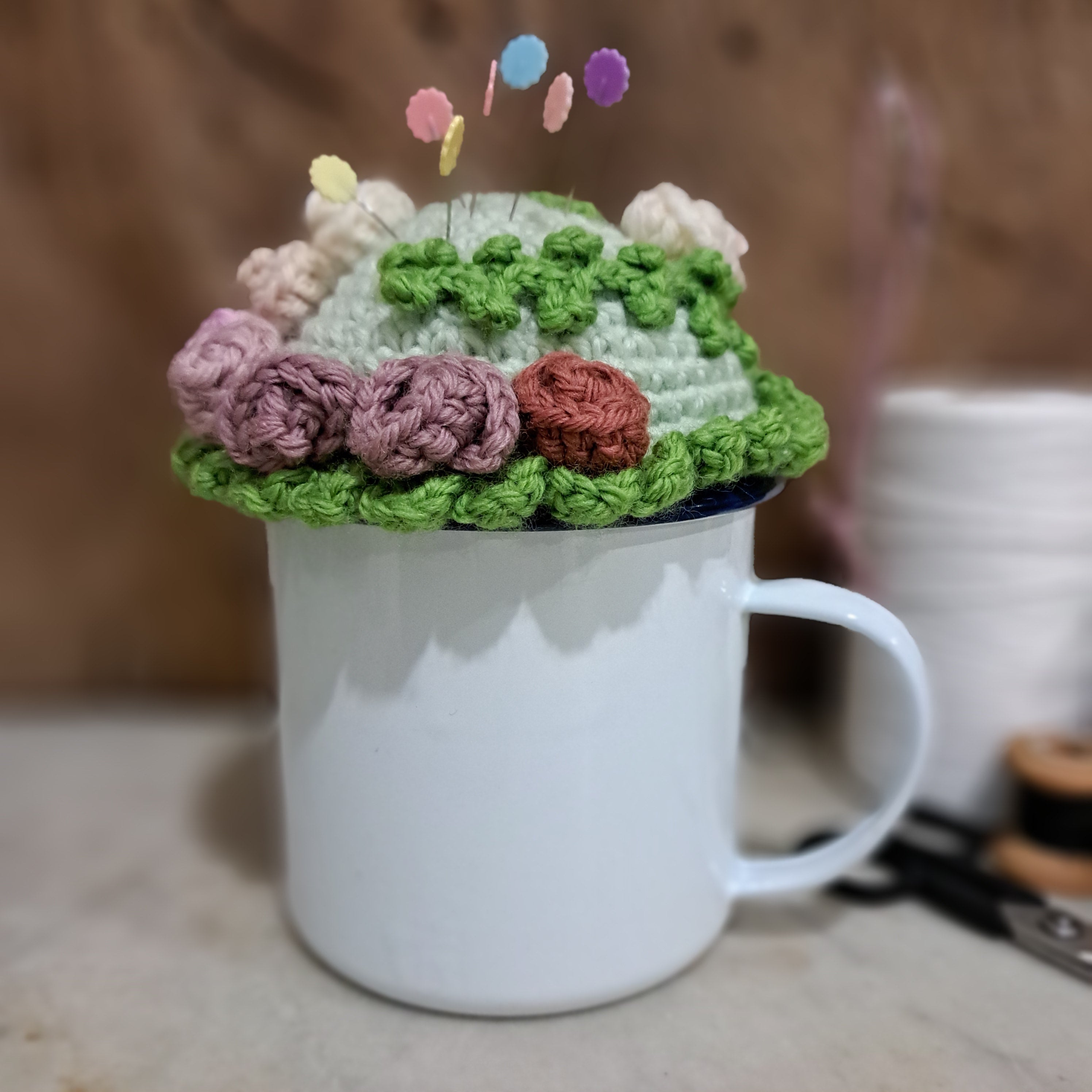 Crochet pin cushion with pretty roses in a sturdy enamel tin mug