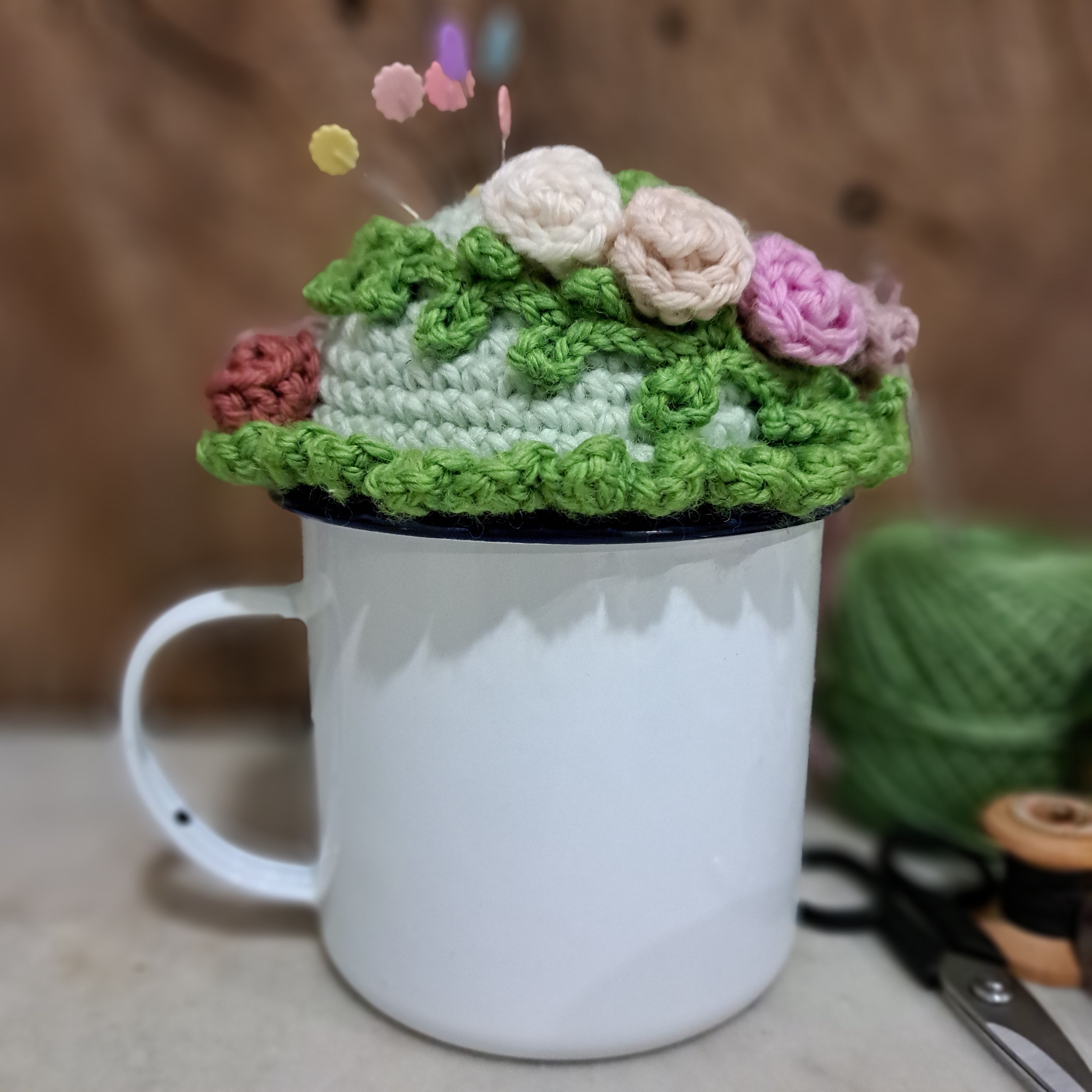 Crochet pin cushion with pretty roses in a sturdy enamel tin mug