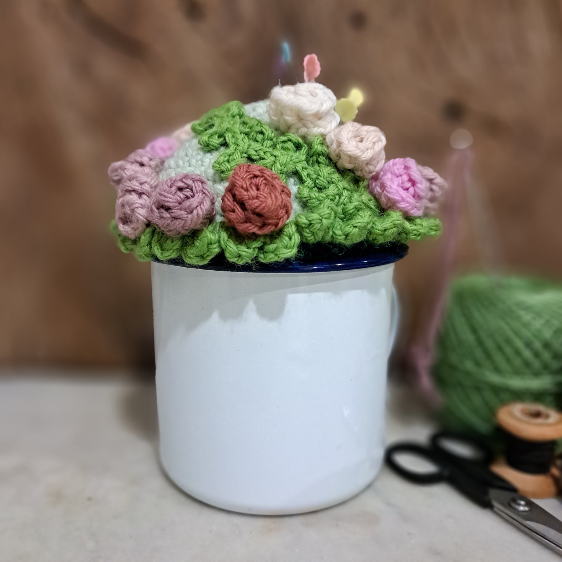 Crochet pin cushion with pretty roses in a sturdy enamel tin mug