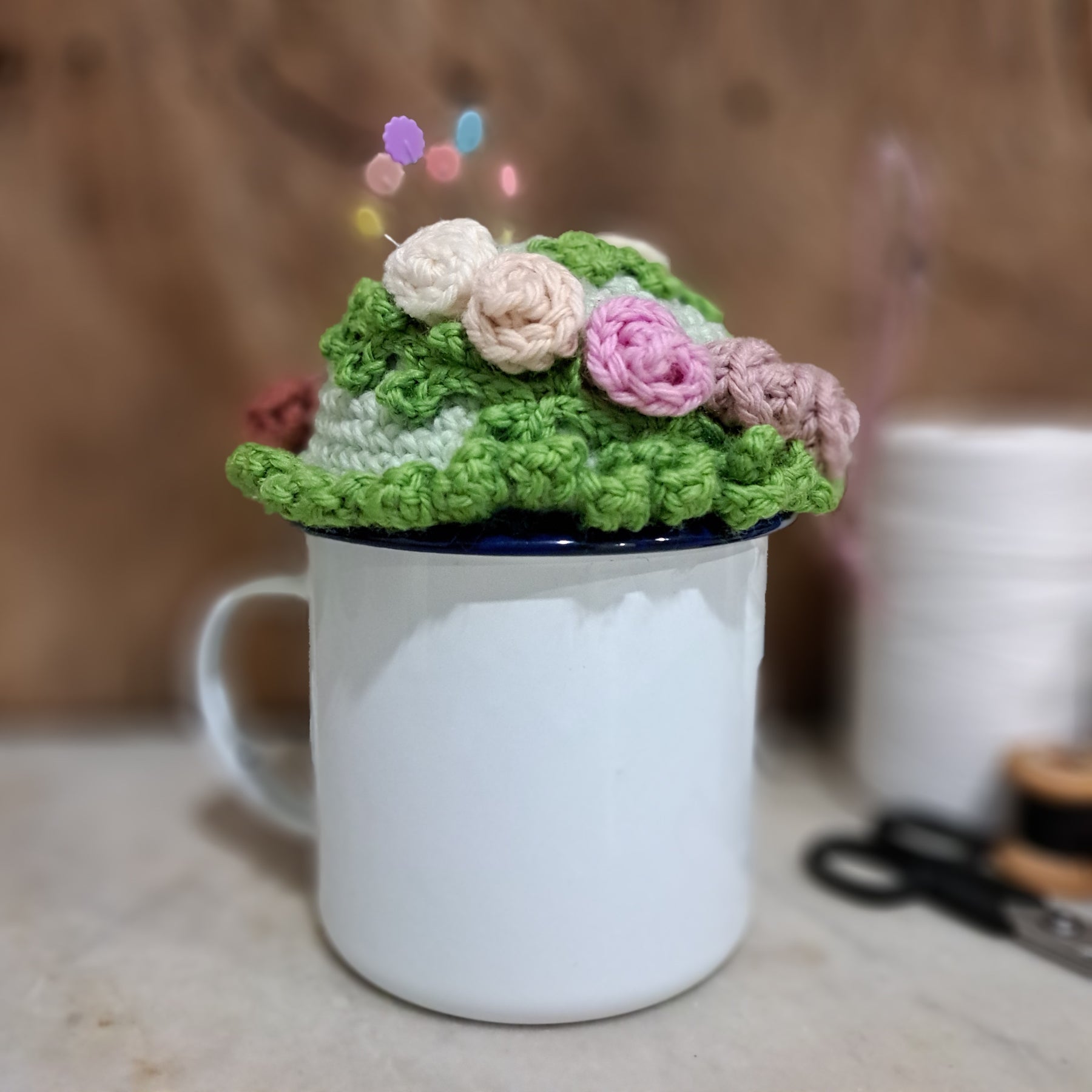 Crochet pin cushion with pretty roses in a sturdy enamel tin mug