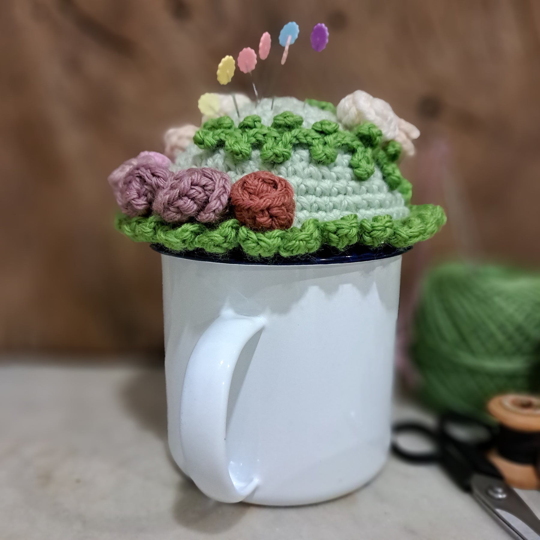 Crochet pin cushion with pretty roses in a sturdy enamel tin mug
