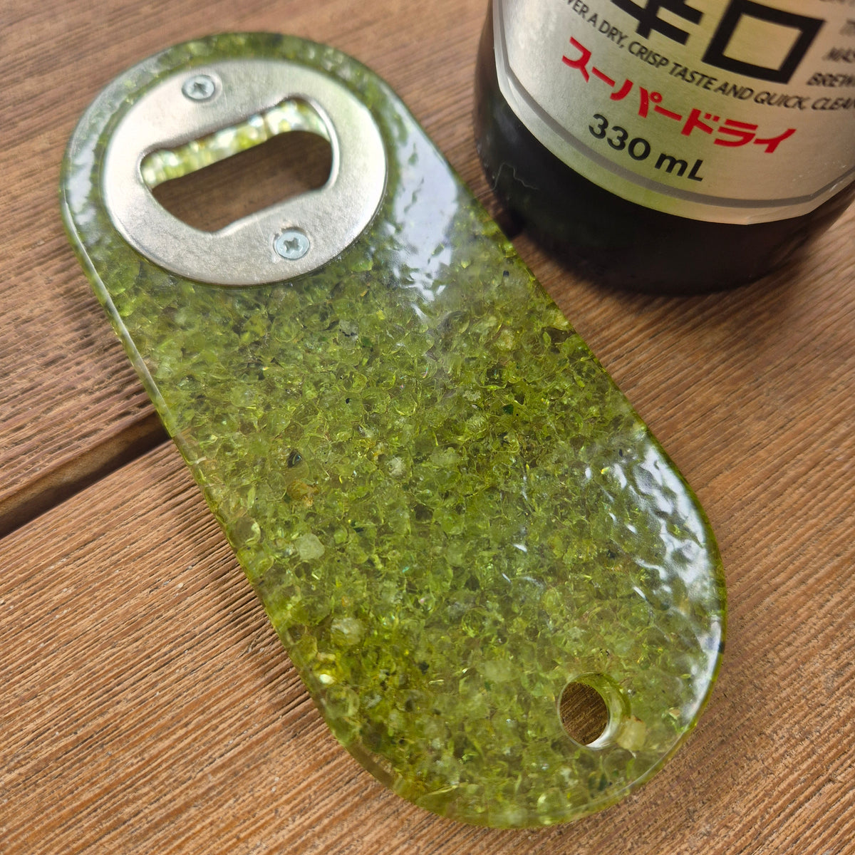 Resin bottle opener with inlaid peridot stones