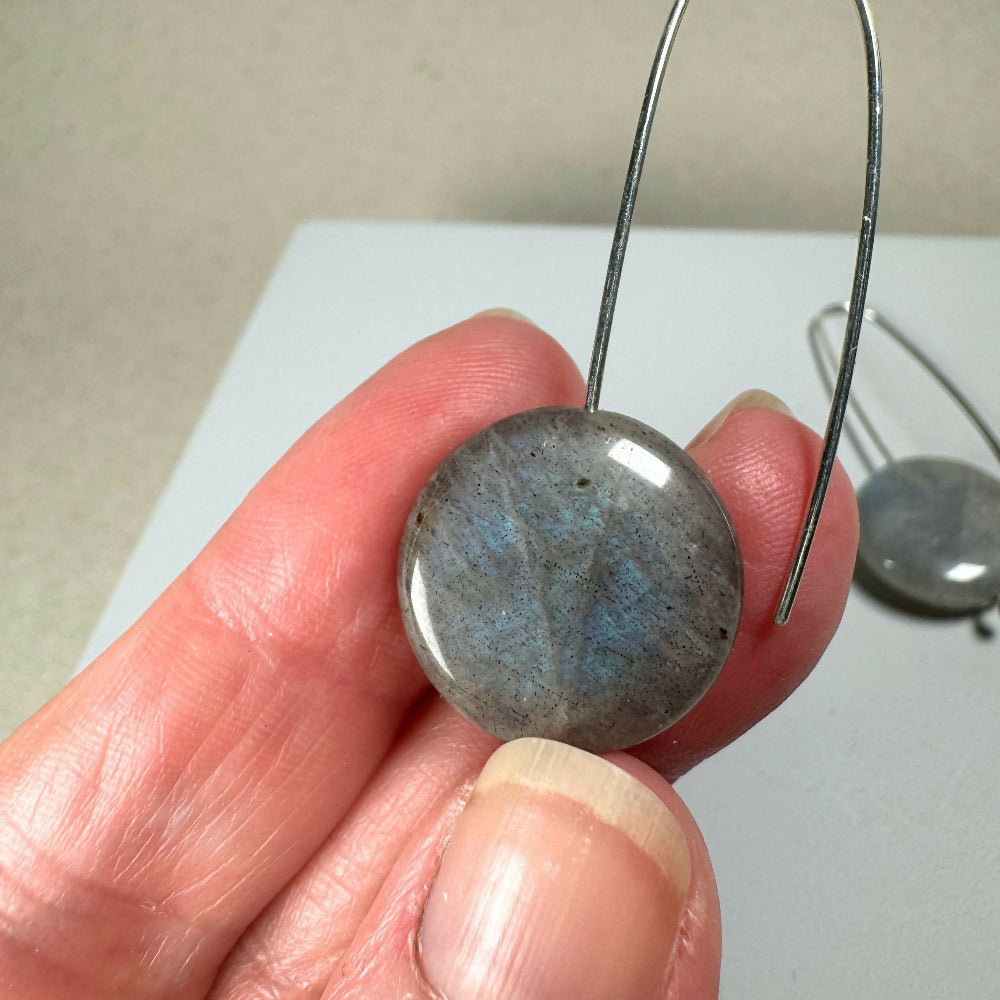 Labradorite earrings close up on hand other side