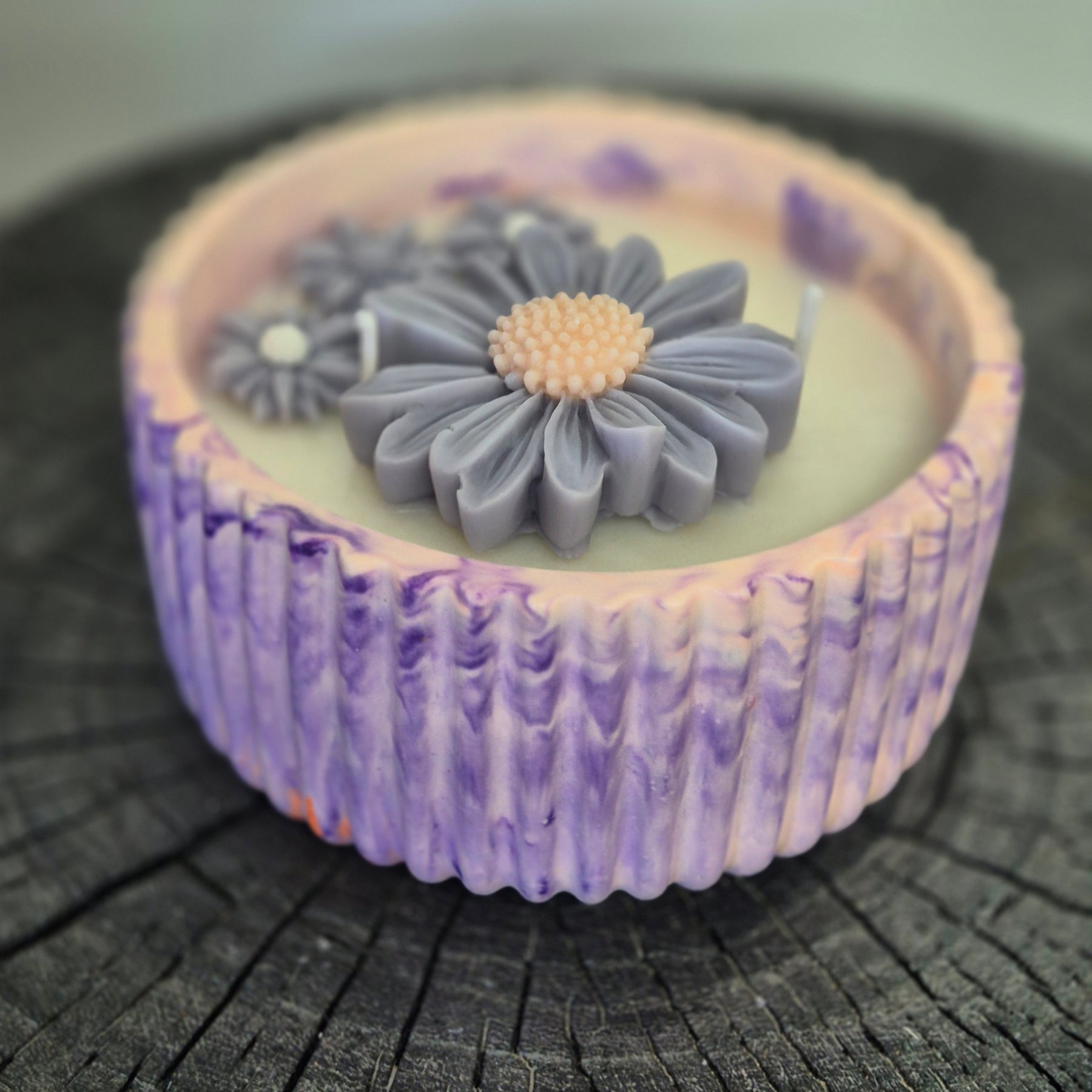Round orange and purple concrete bowl candle with rose and lavender scent