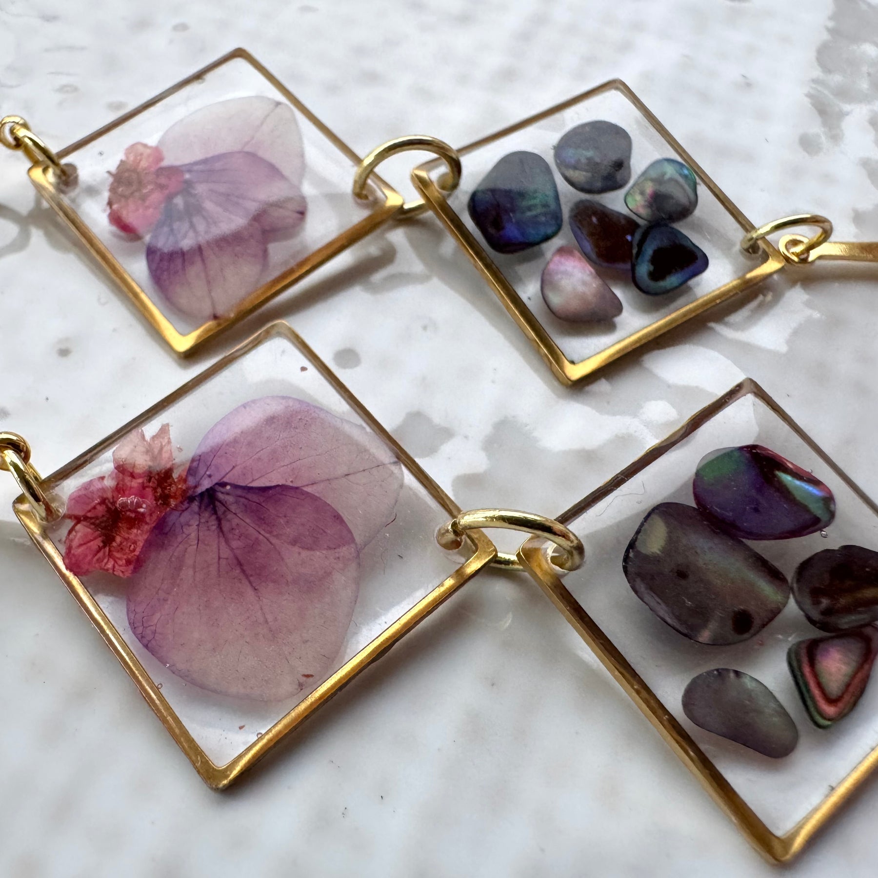 Double rhombus cowrie shell and pressed flower resin earrings