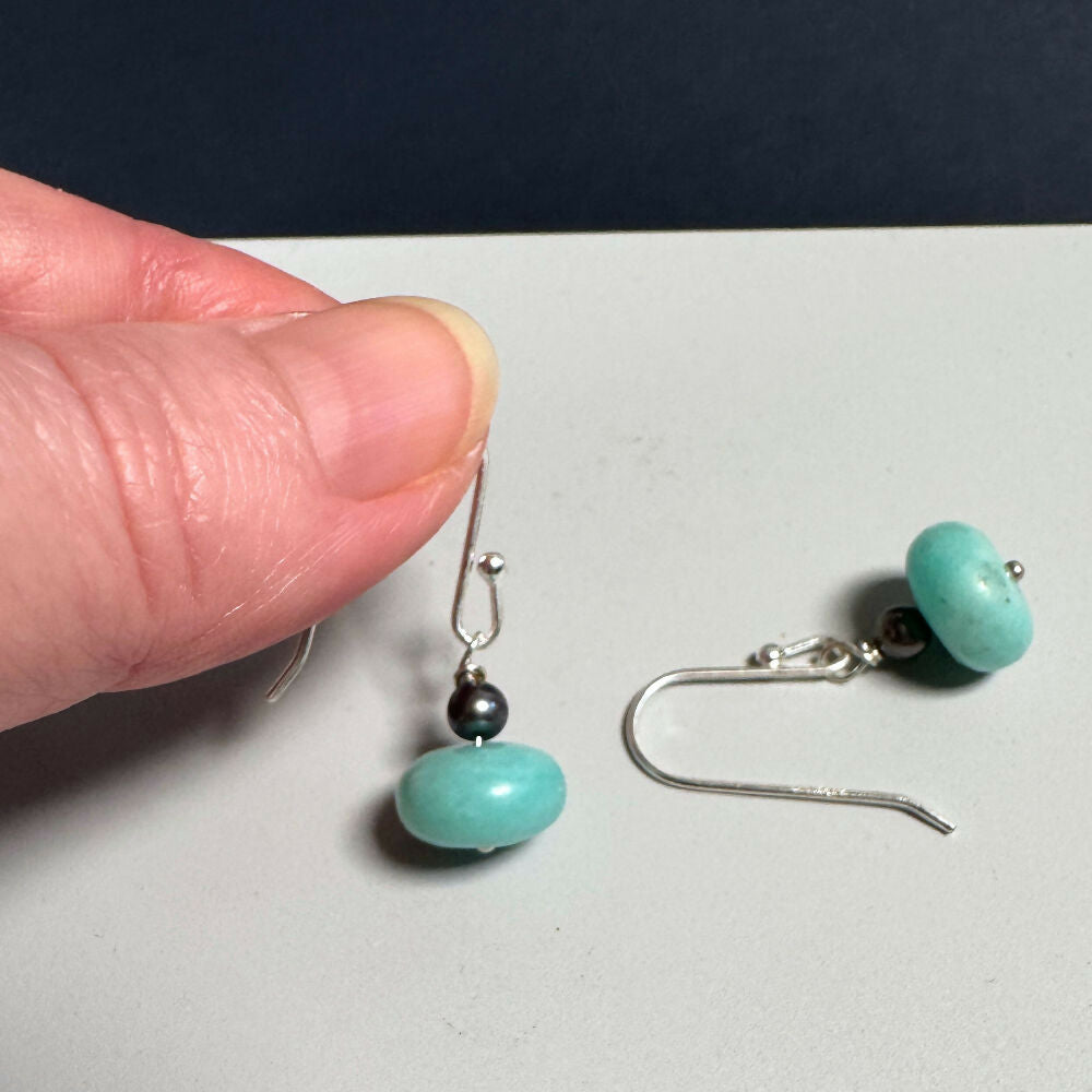 Amazonite & pearl earrings on hand and flat on mid-grey & black background