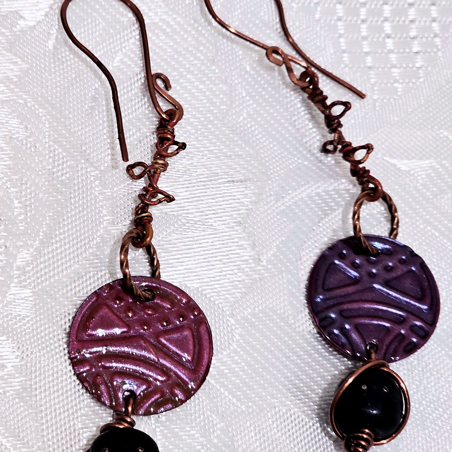 Suspended Pressed Metal Discs with Barbed Wirework Link and Black Matt Lampwork bead