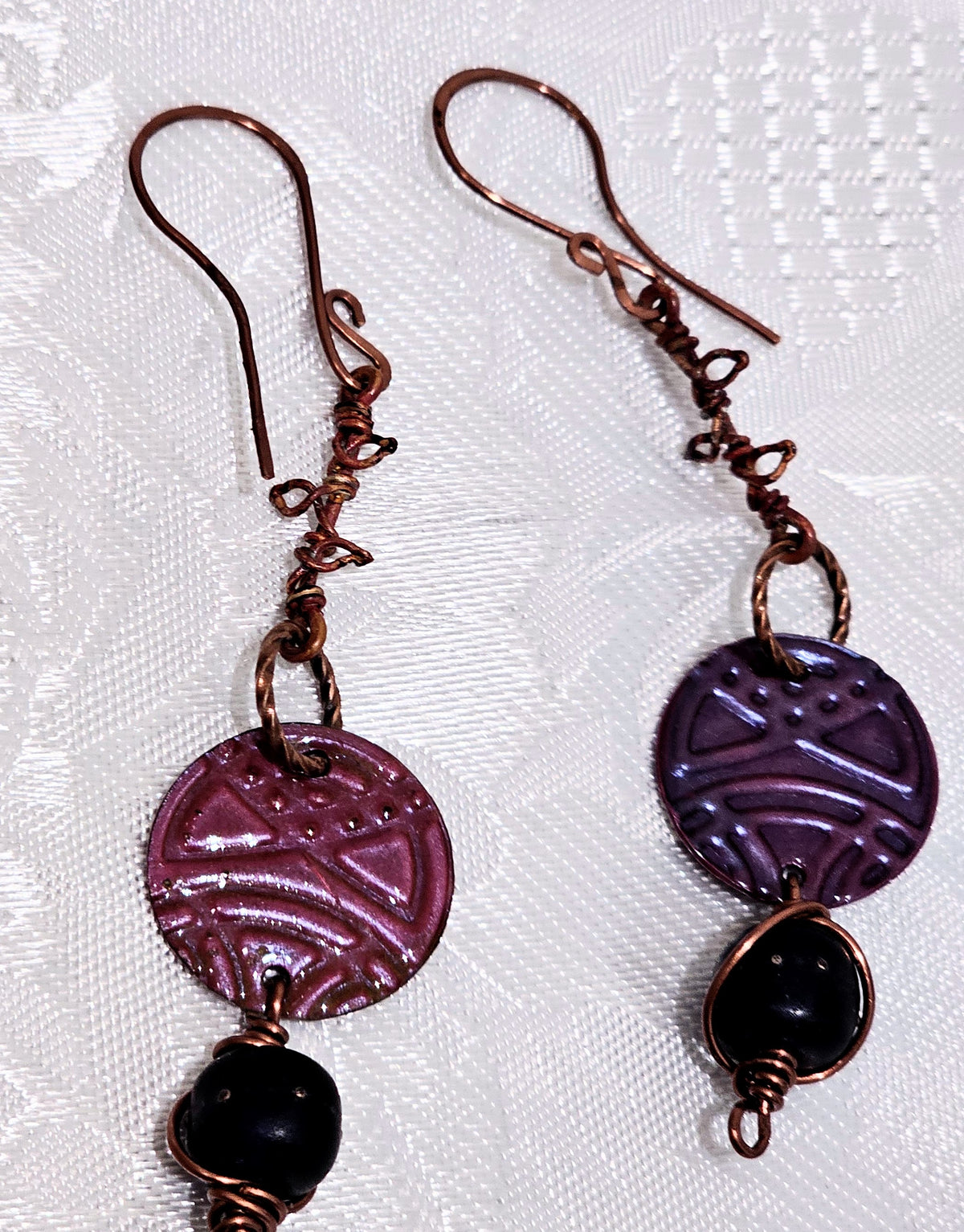 Suspended Pressed Metal Discs with Barbed Wirework Link and Black Matt Lampwork bead