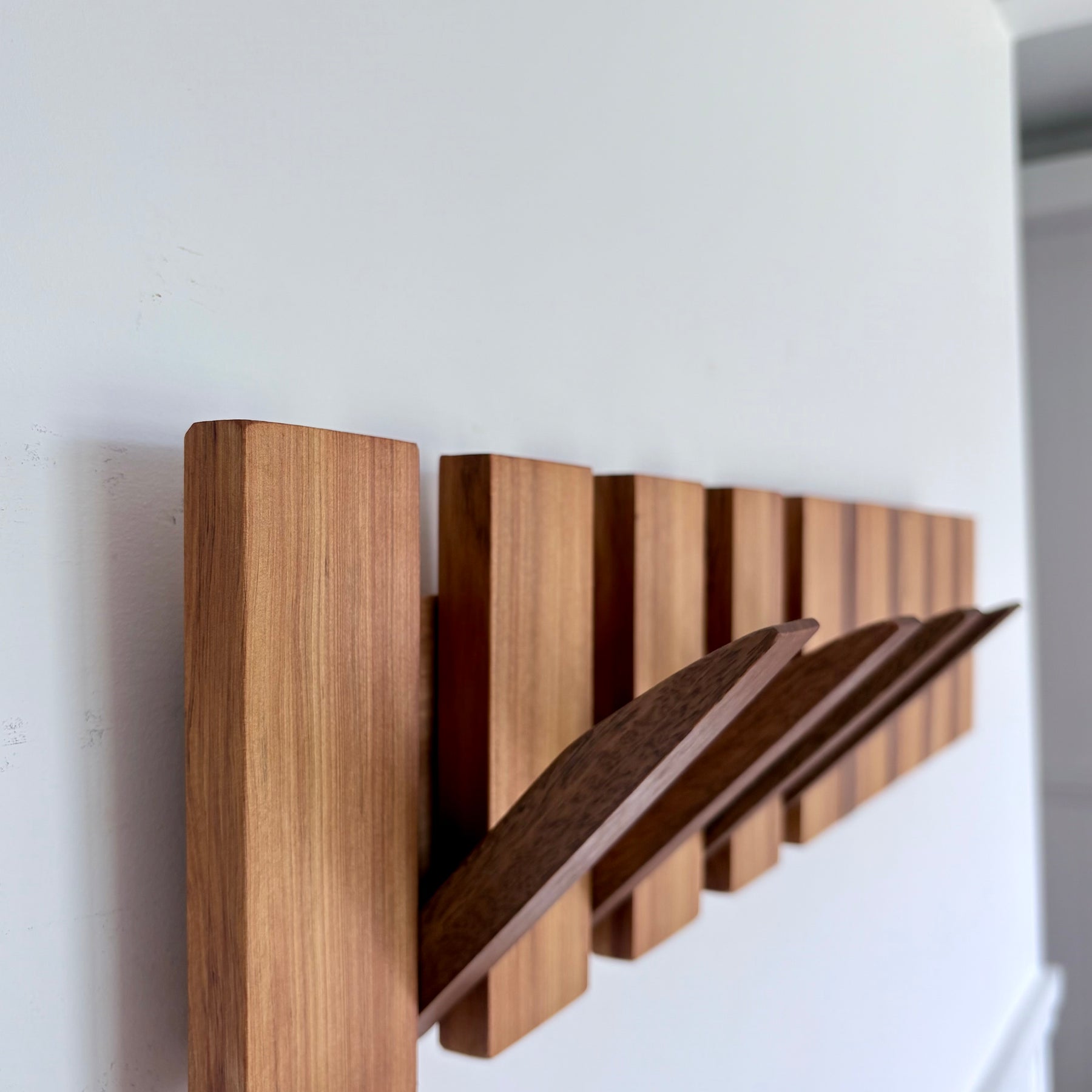 Two tone spotted gum and cypress horizon line piano style coatrack
