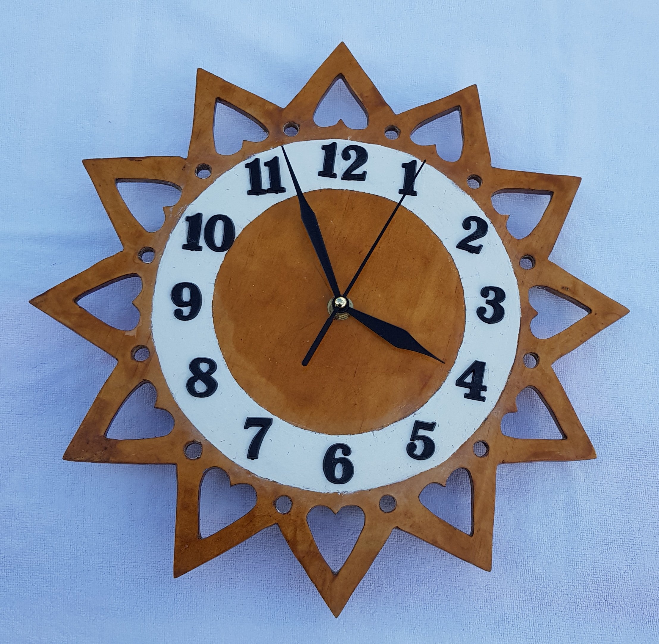 Clock 3:  Has a 30 cm scroll sawn decrative surround.