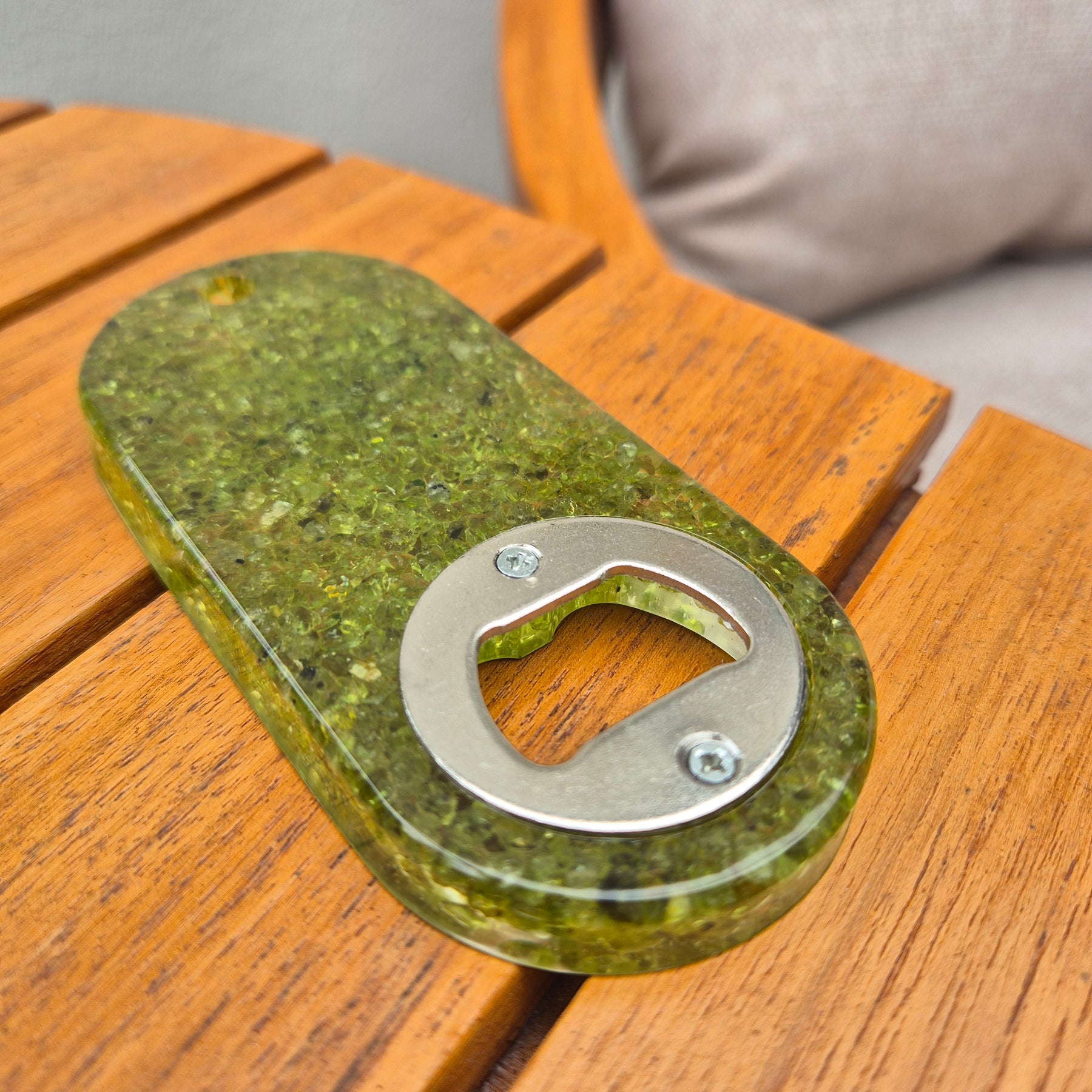 Resin bottle opener with inlaid peridot stones