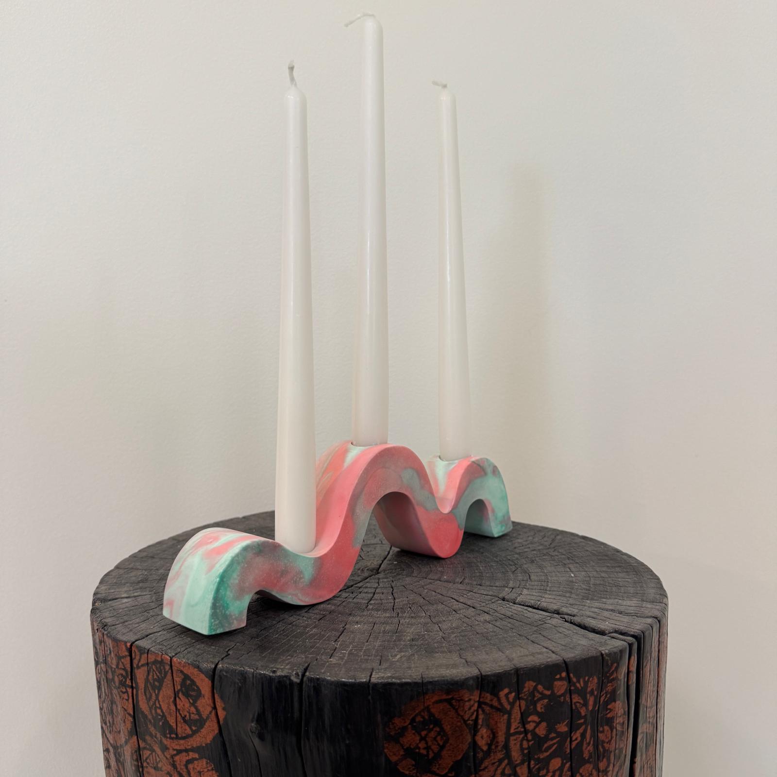 Red and green and gold wavy concrete holder for taper candles