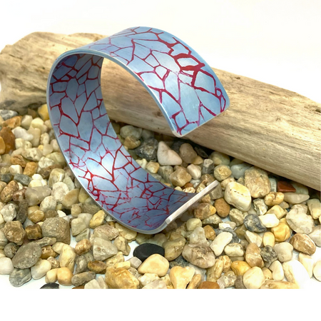 Printed and dyed pale blue and crimson anodized aluminium bangle