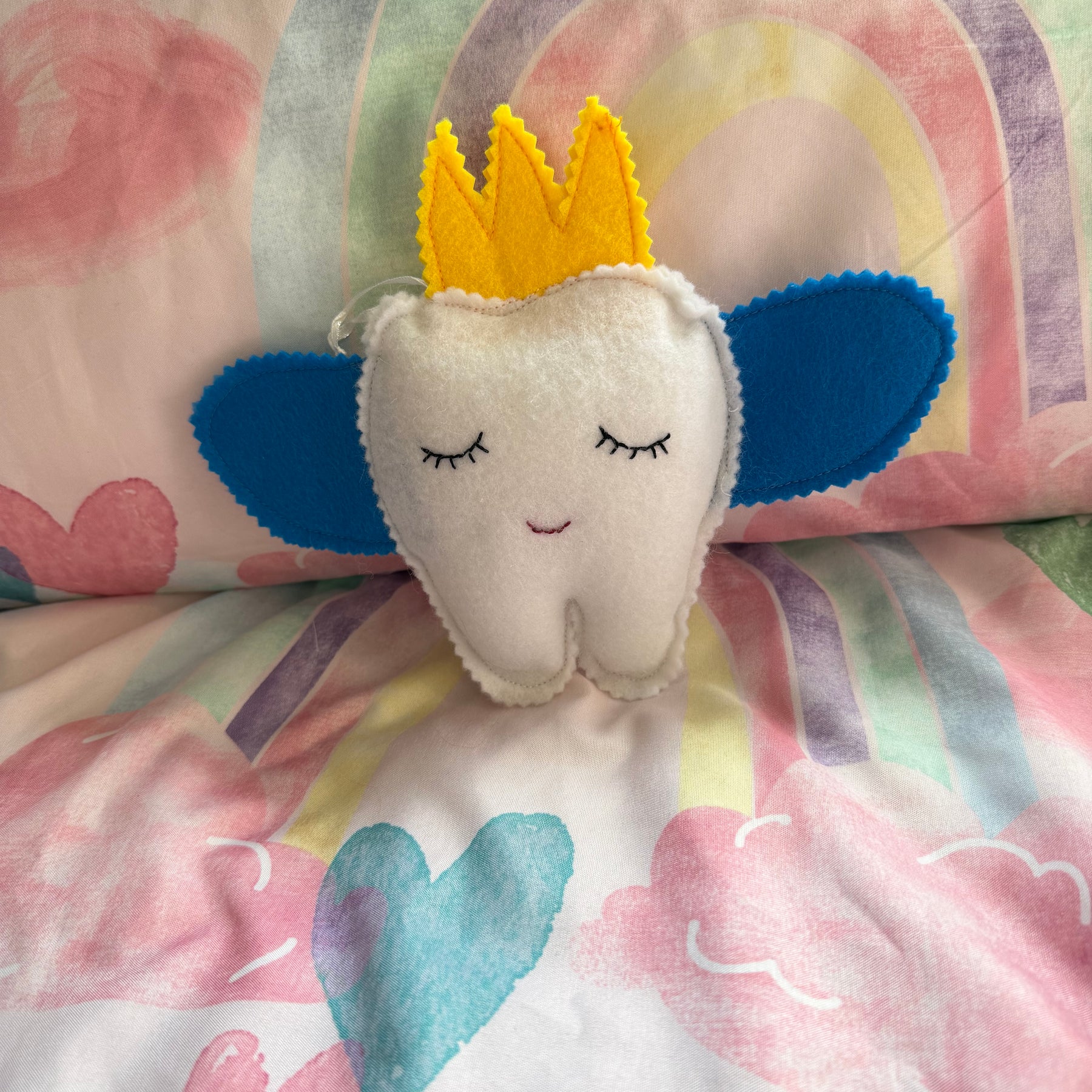 Tooth fairy snuggle toy with tooth pouch