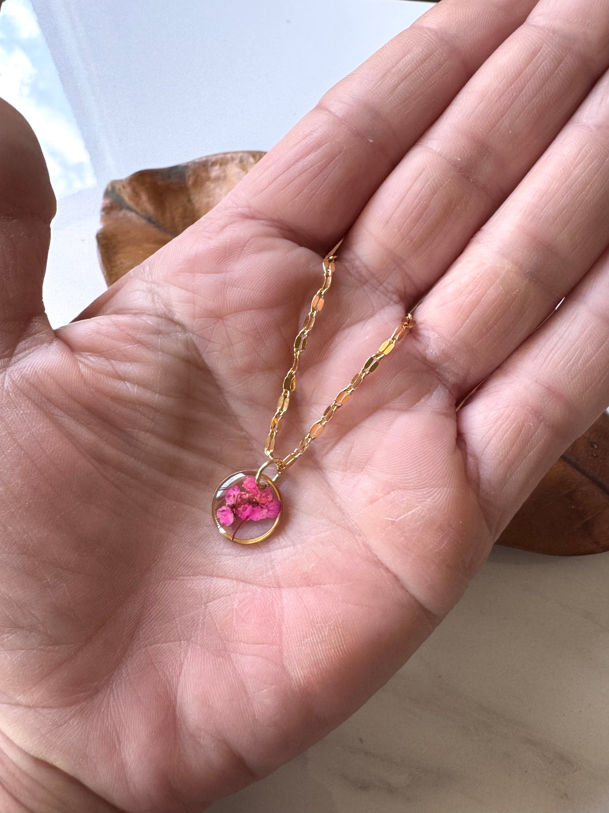 Gold plated resin necklace with fuchsia pink wildflower
