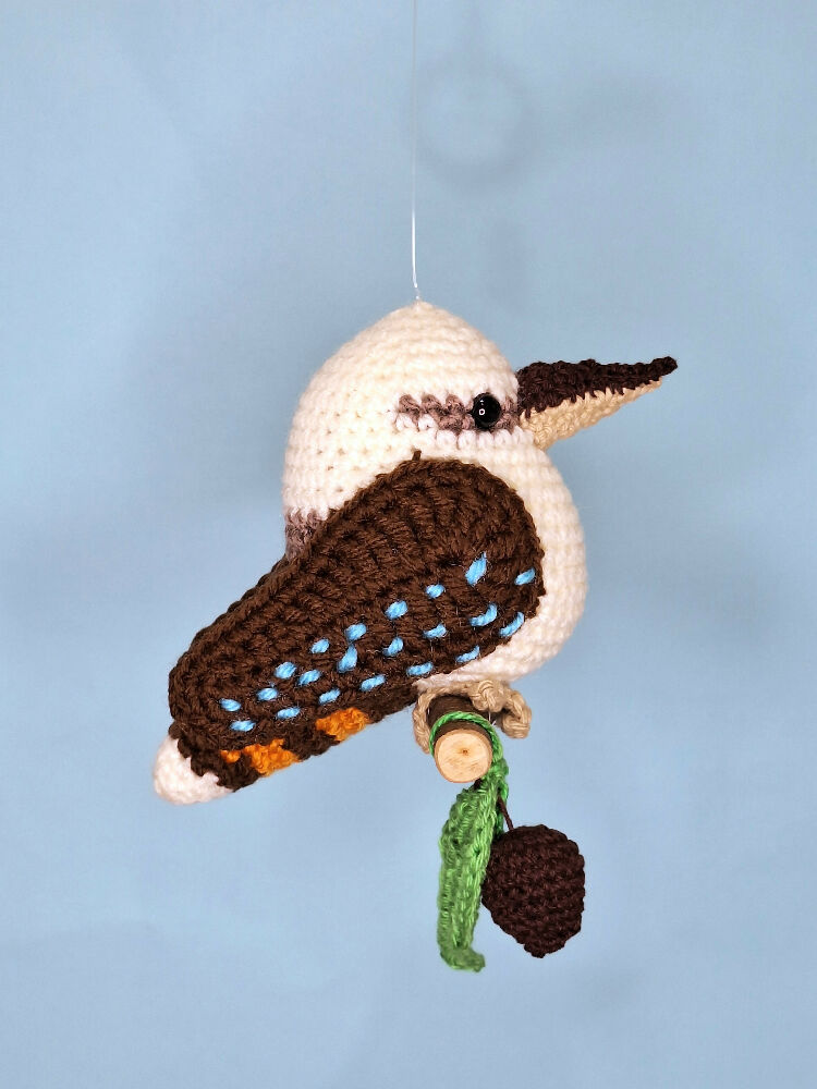 Crocheted laughing Kookaburra room decoration on perch