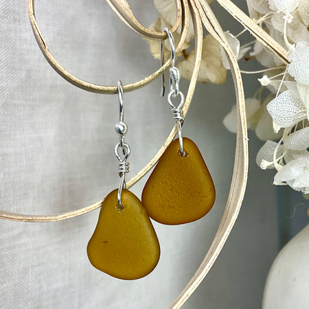 Amber sea glass earrings with argentium silver.