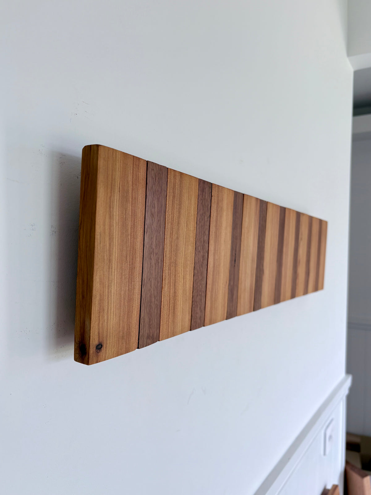 Two tone spotted gum and cypress horizon line piano style coatrack