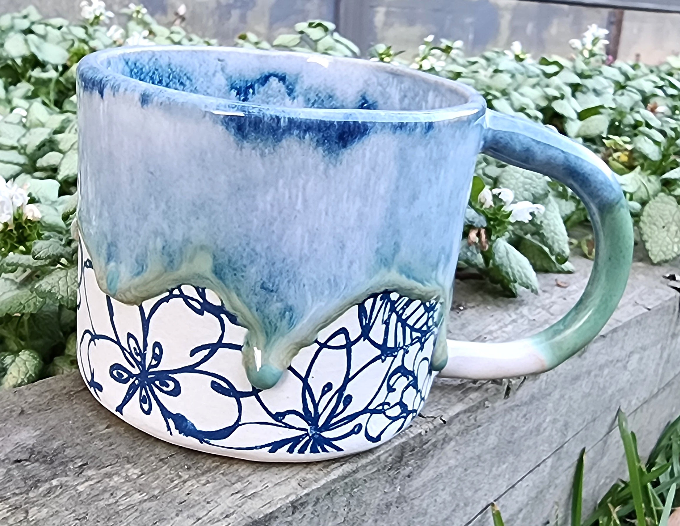 Ceramic floral mug with drippy glaze