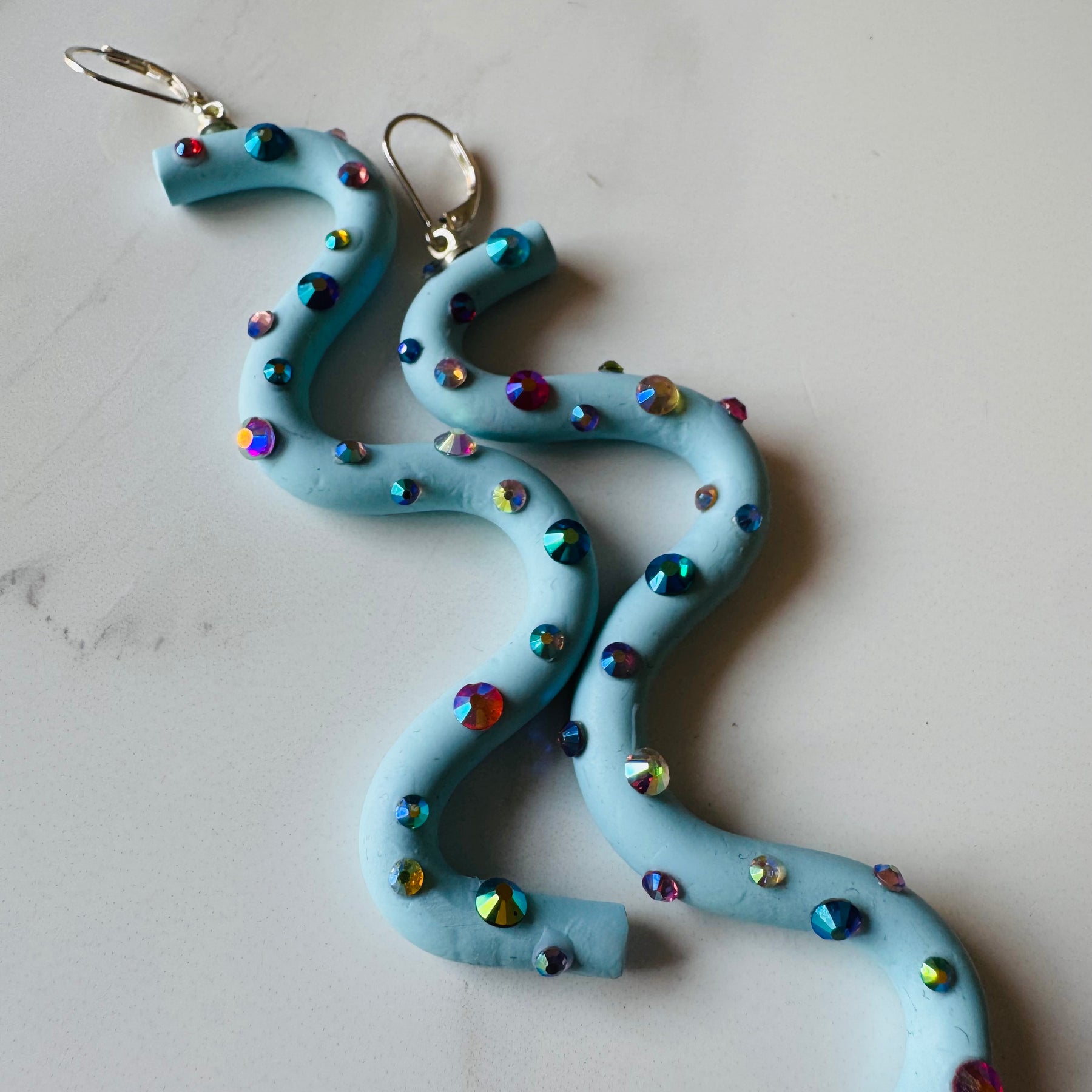 Pastel blue squiggle polymer clay earrings with holographic gems