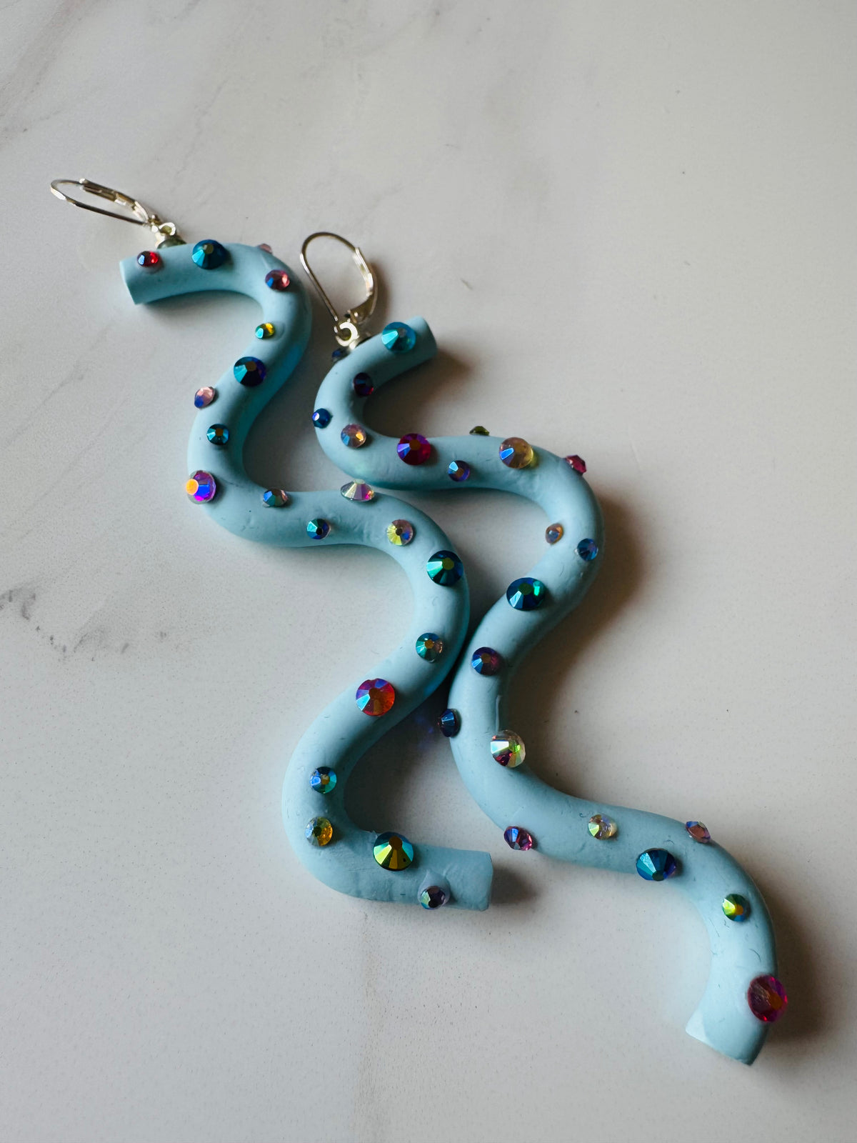 Pastel blue squiggle polymer clay earrings with holographic gems