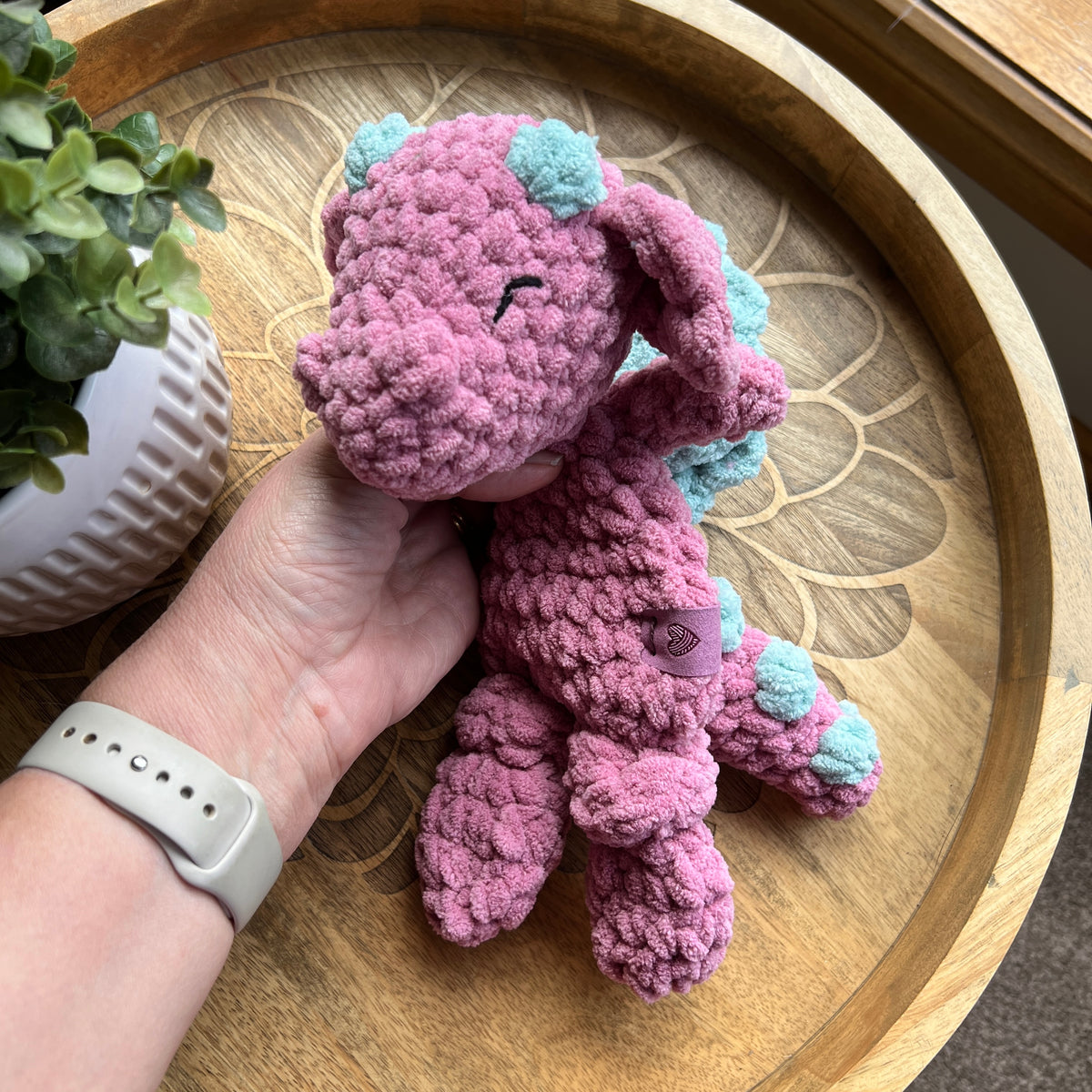 Handmade crochet Mini Dragon modern lovey with knotted legs and rainbow spikes.