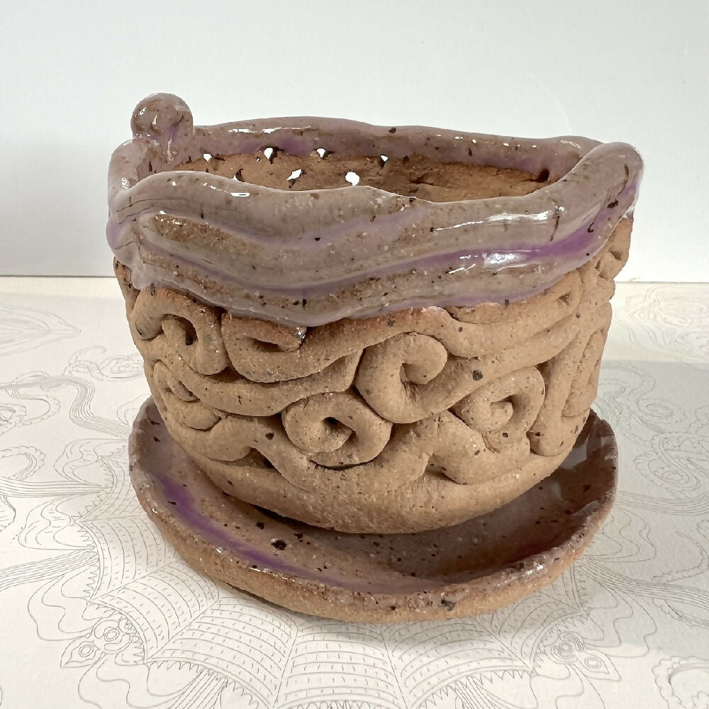 Coil pot with saucer detail