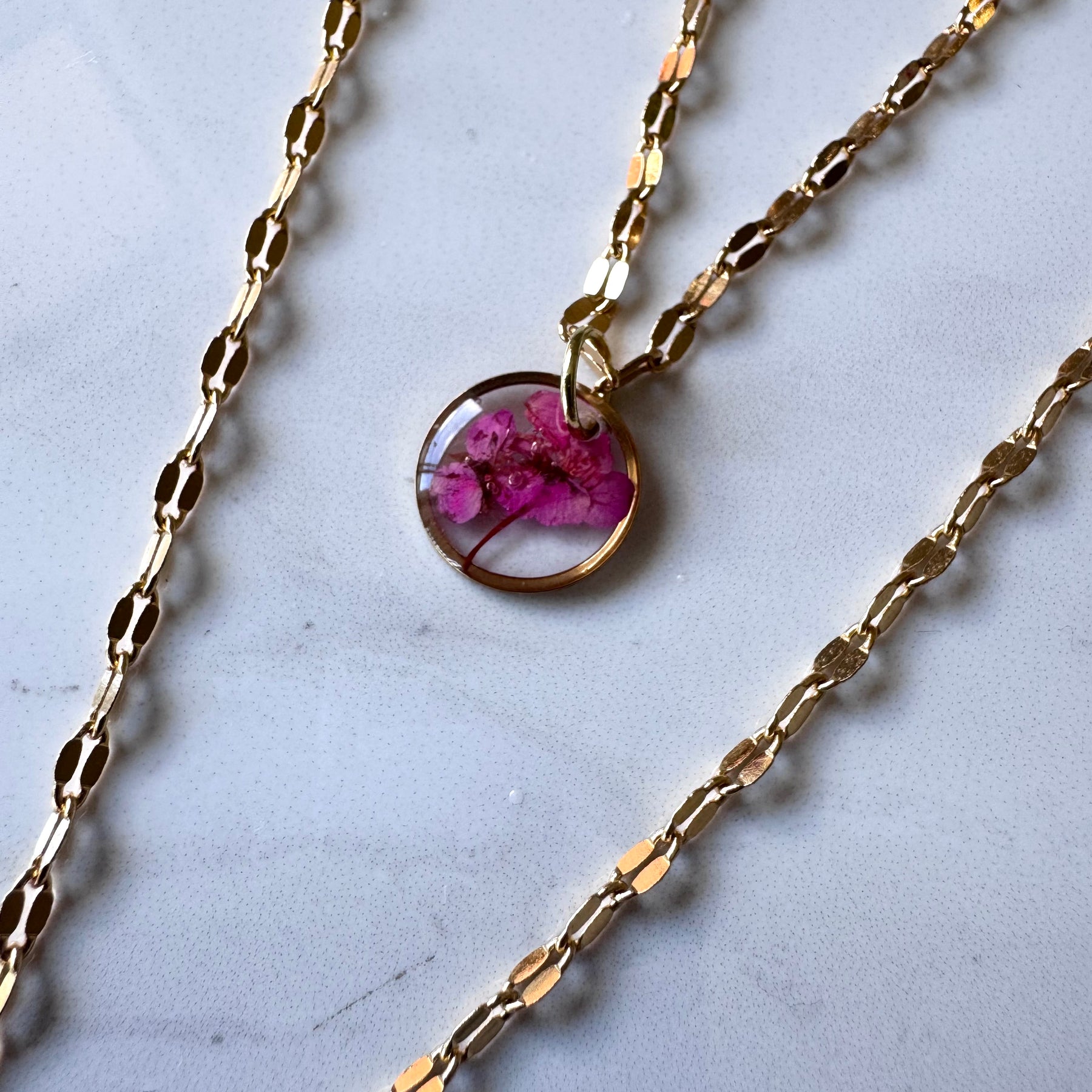 Gold plated resin necklace with fuchsia pink wildflower