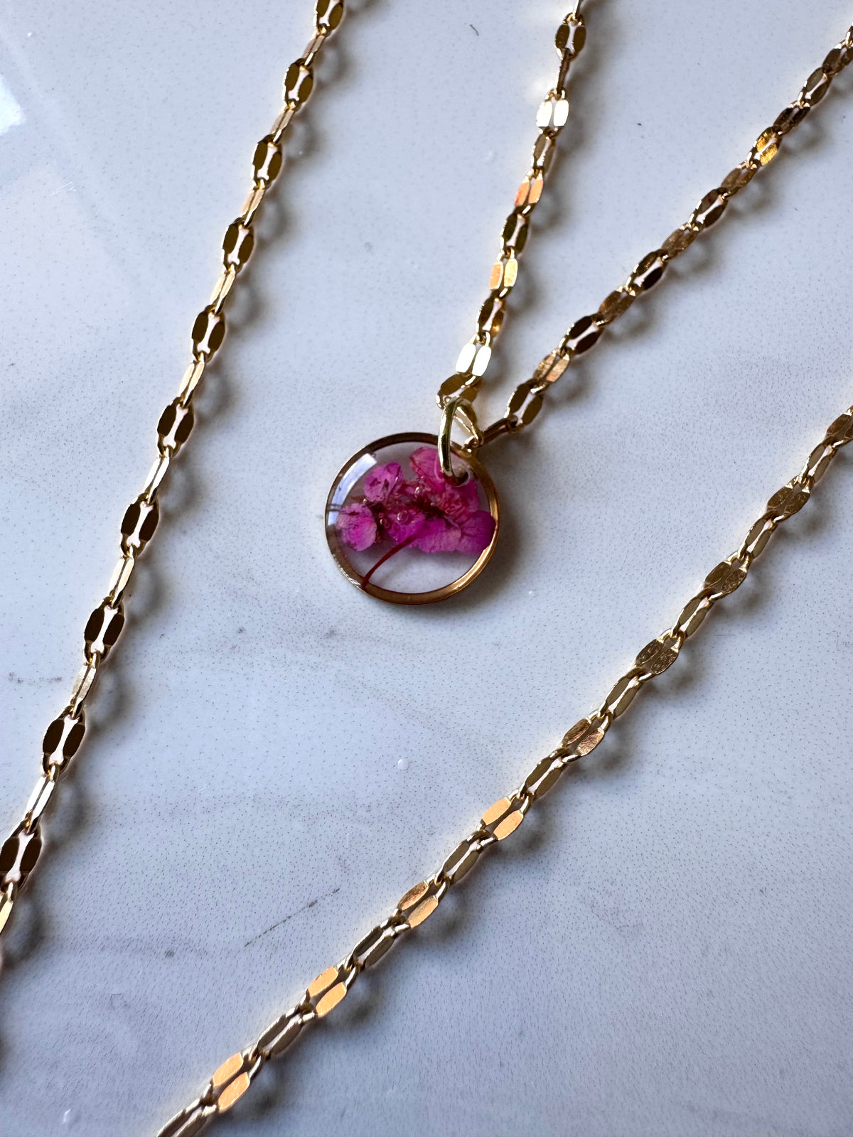 Gold plated resin necklace with fuchsia pink wildflower
