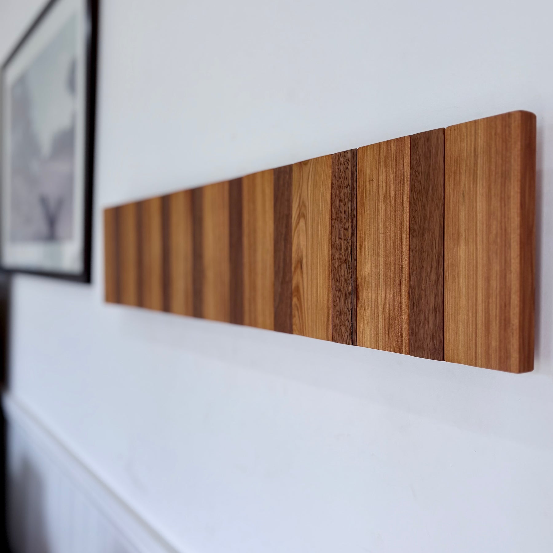 Two tone spotted gum and cypress horizon line piano style coatrack