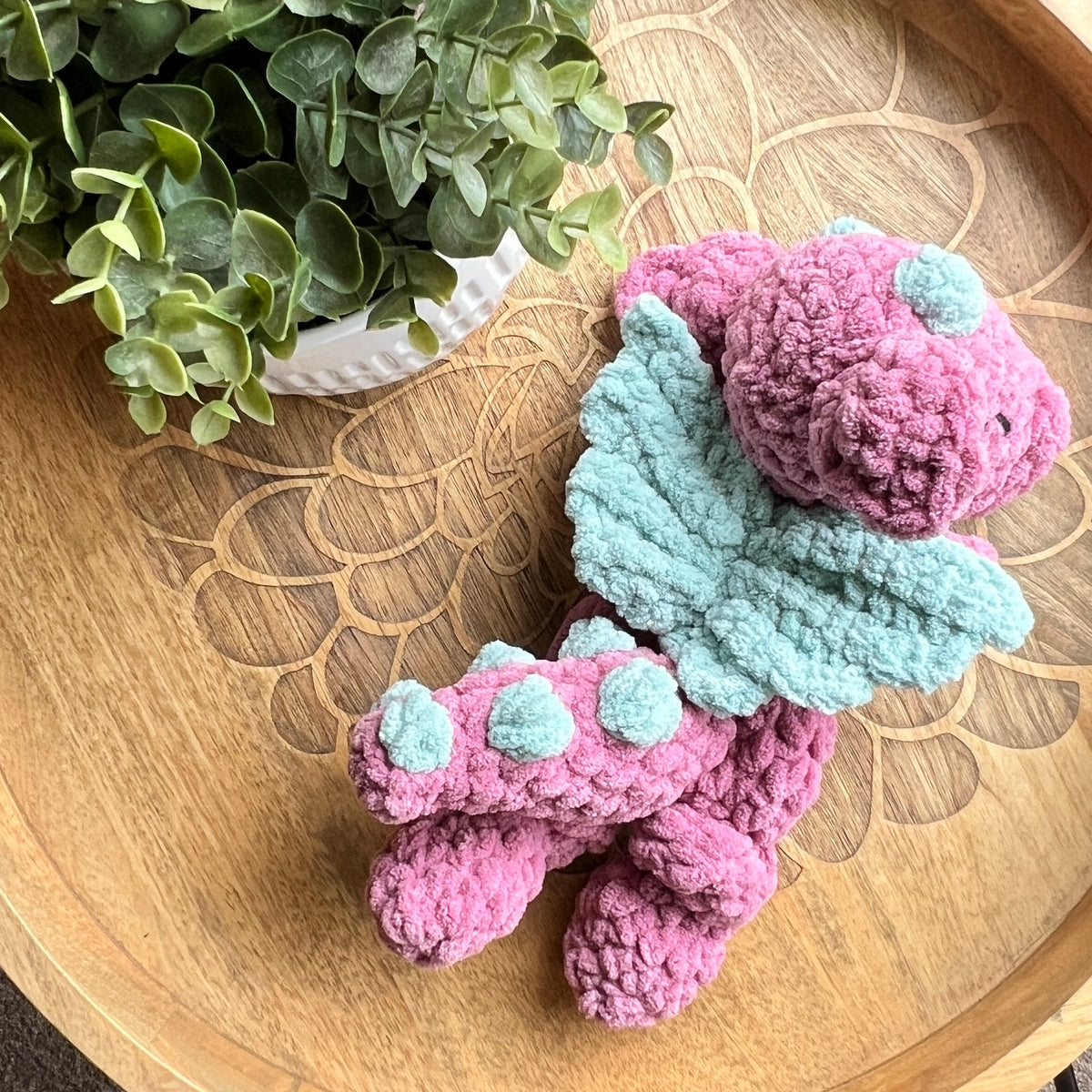 Handmade crochet Mini Dragon modern lovey with knotted legs and rainbow spikes.