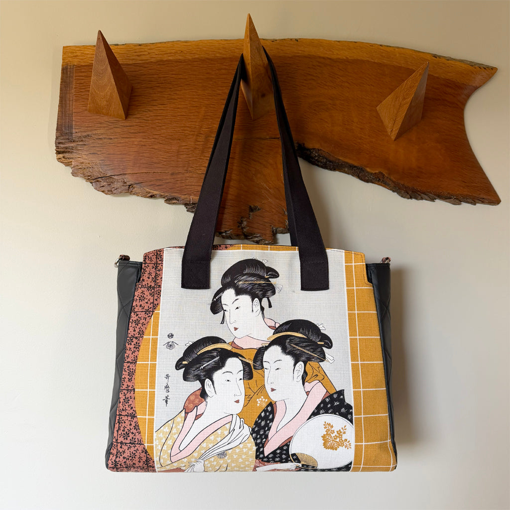 Tote-style handbag with side pockets and main zip