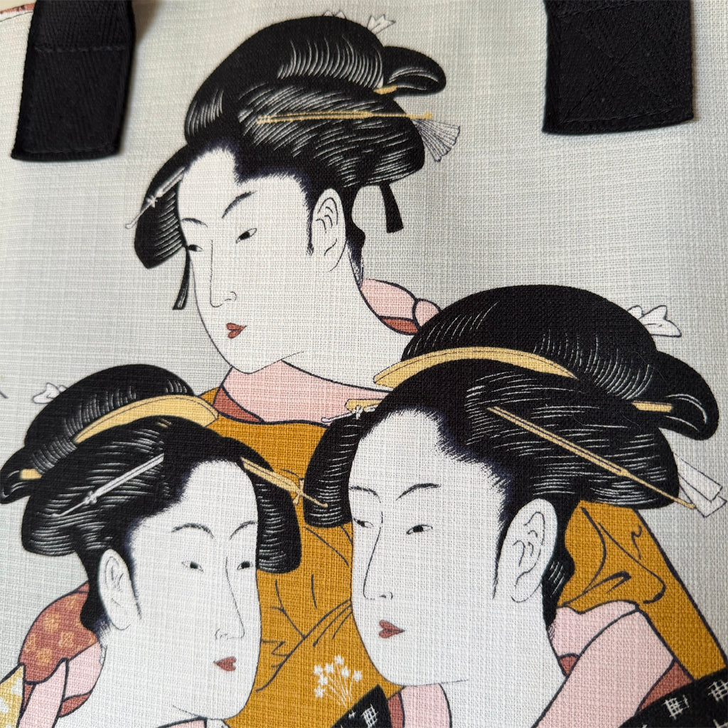 Tote-style handbag with side pockets and main zip