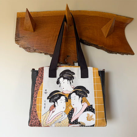 Tote-style handbag with side pockets and main zip