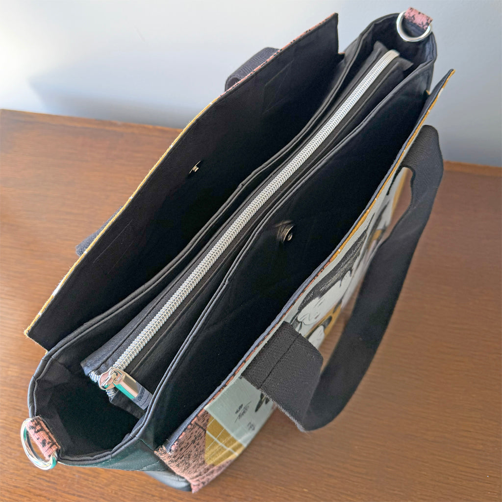 Tote-style handbag with side pockets and main zip