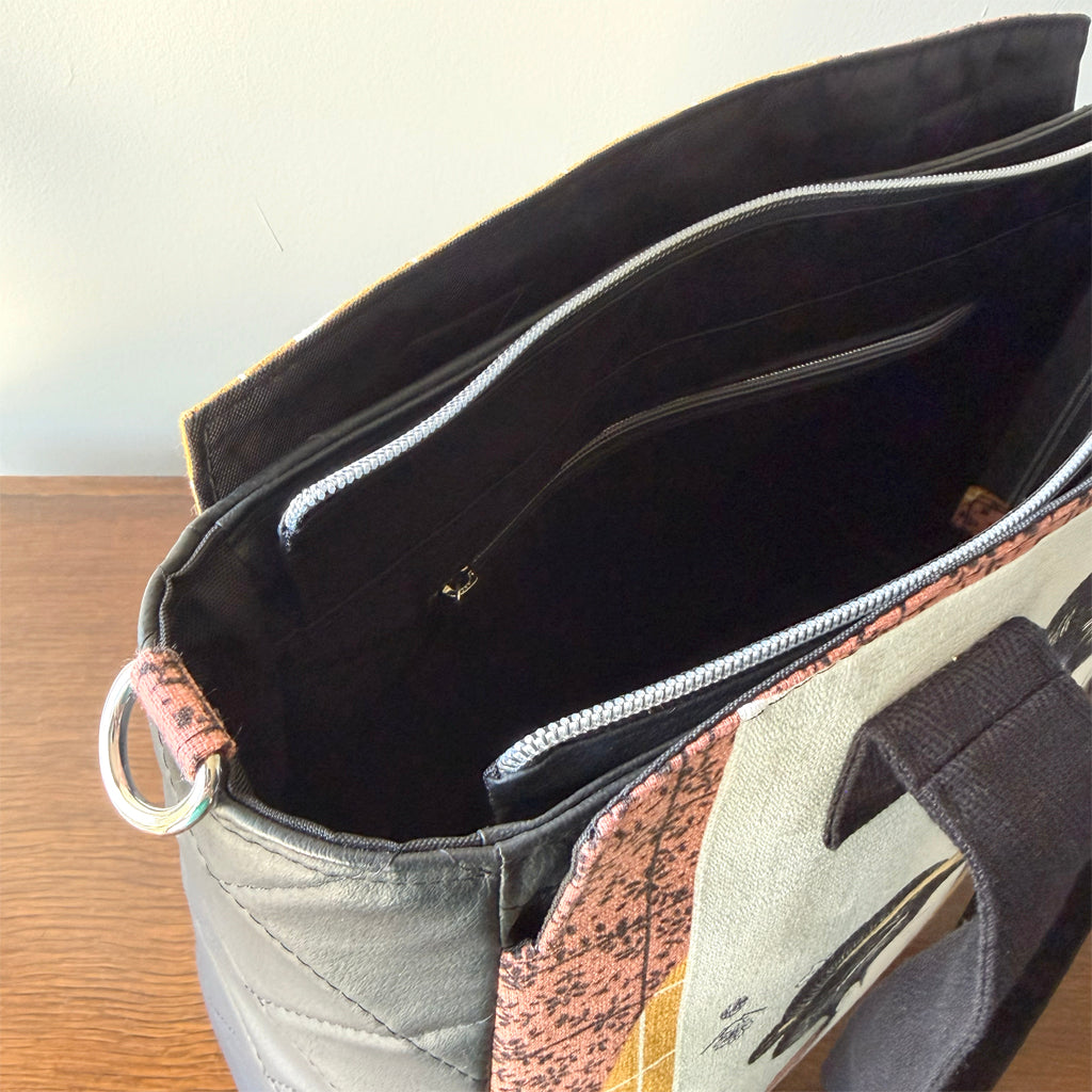 Tote-style handbag with side pockets and main zip