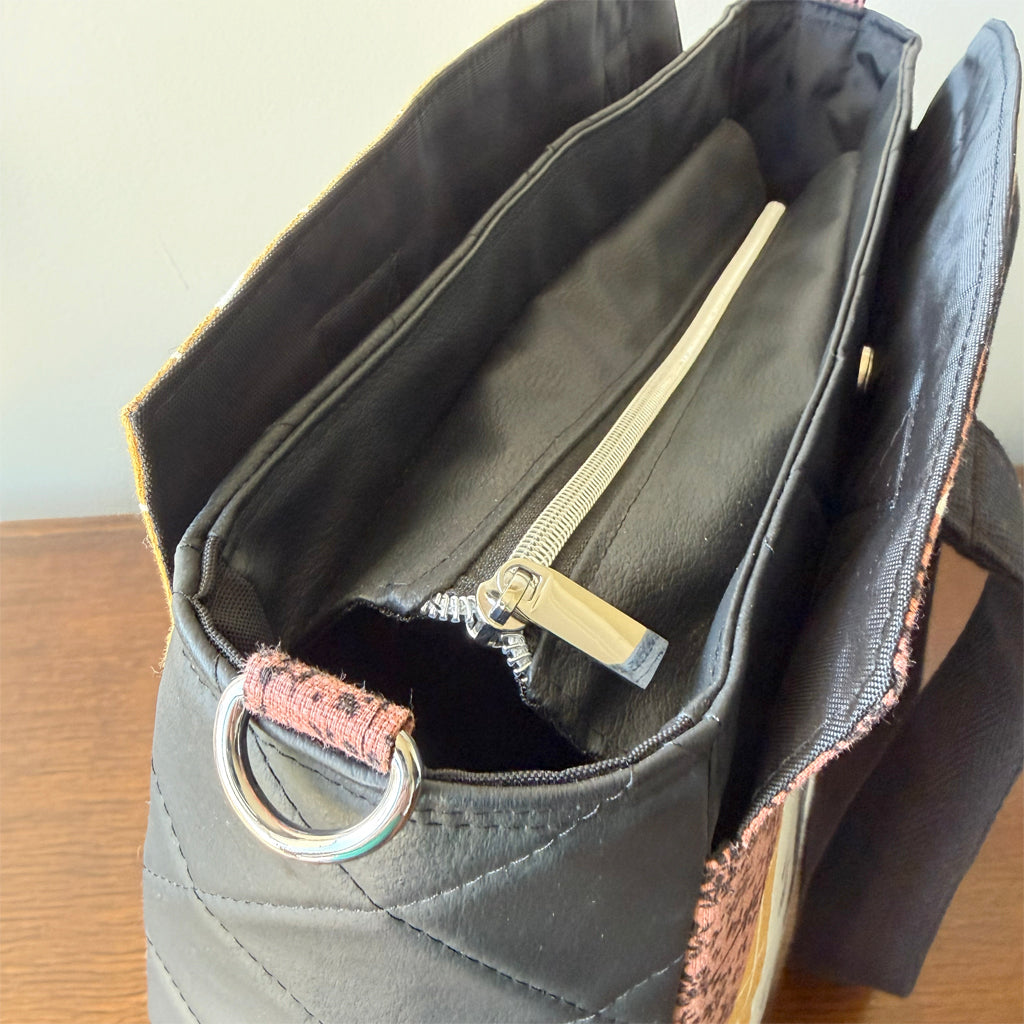 Tote-style handbag with side pockets and main zip