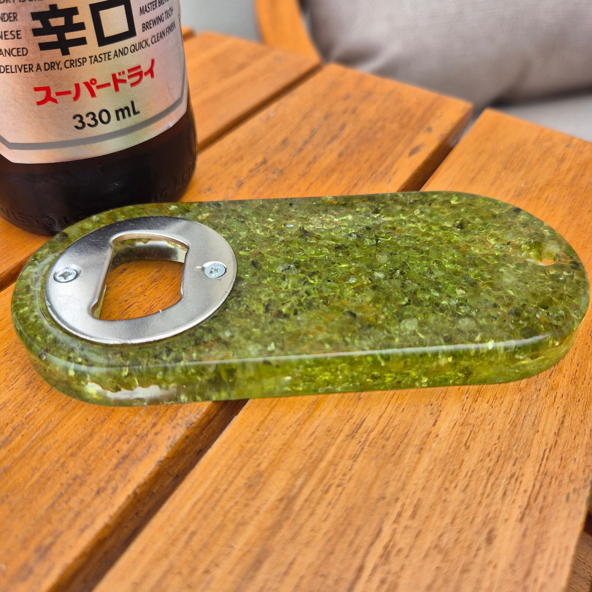 Resin bottle opener with inlaid peridot stones