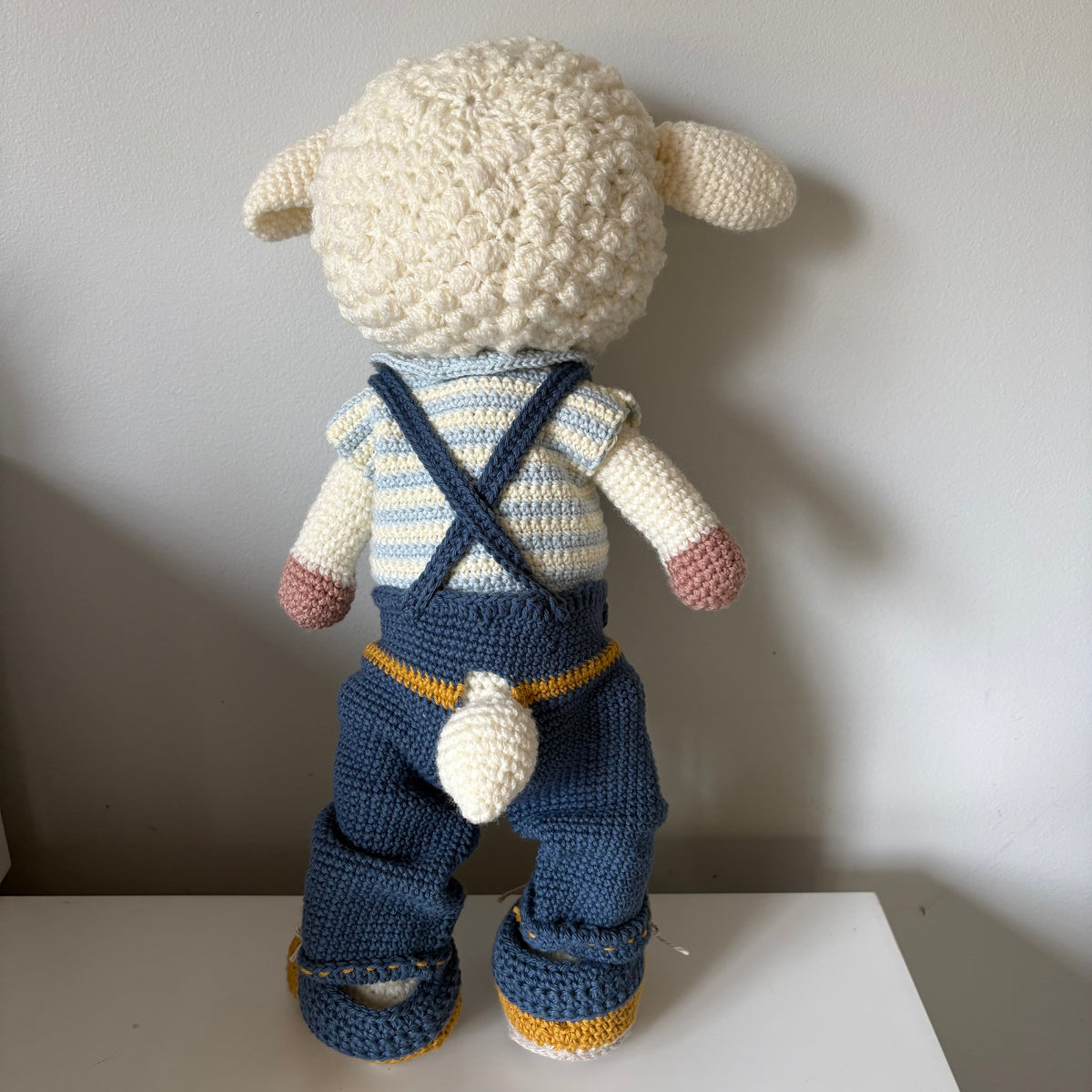 Lamb in overalls and hat