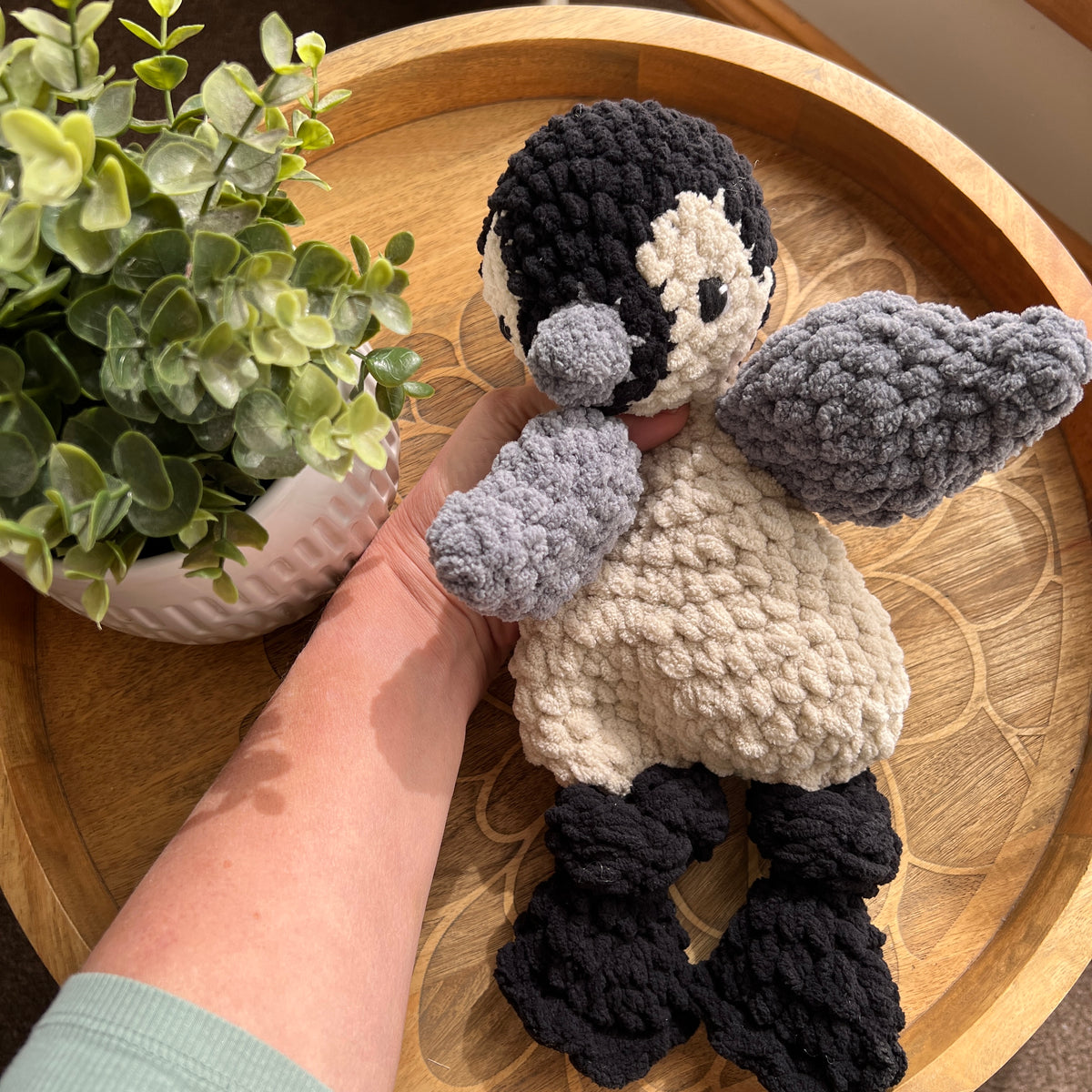 Handmade crochet modern Penguin lovey snuggler with knotted legs.