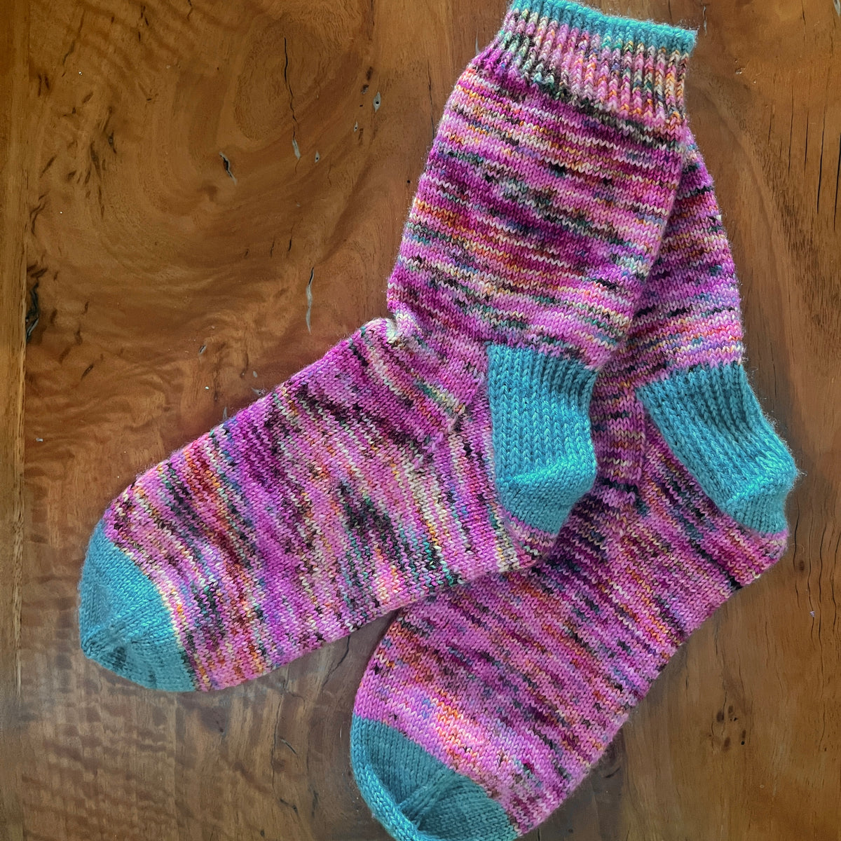 Hand knit socks using Australian hand dyed yarn - pink with teal highlights