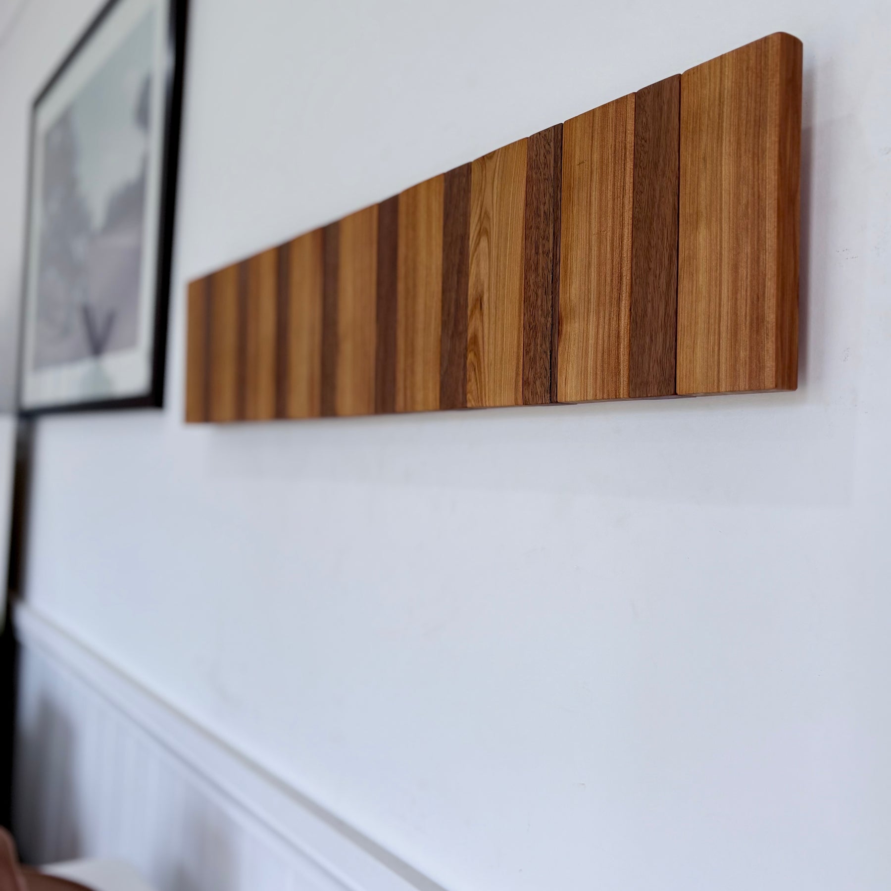 Two tone spotted gum and cypress horizon line piano style coatrack