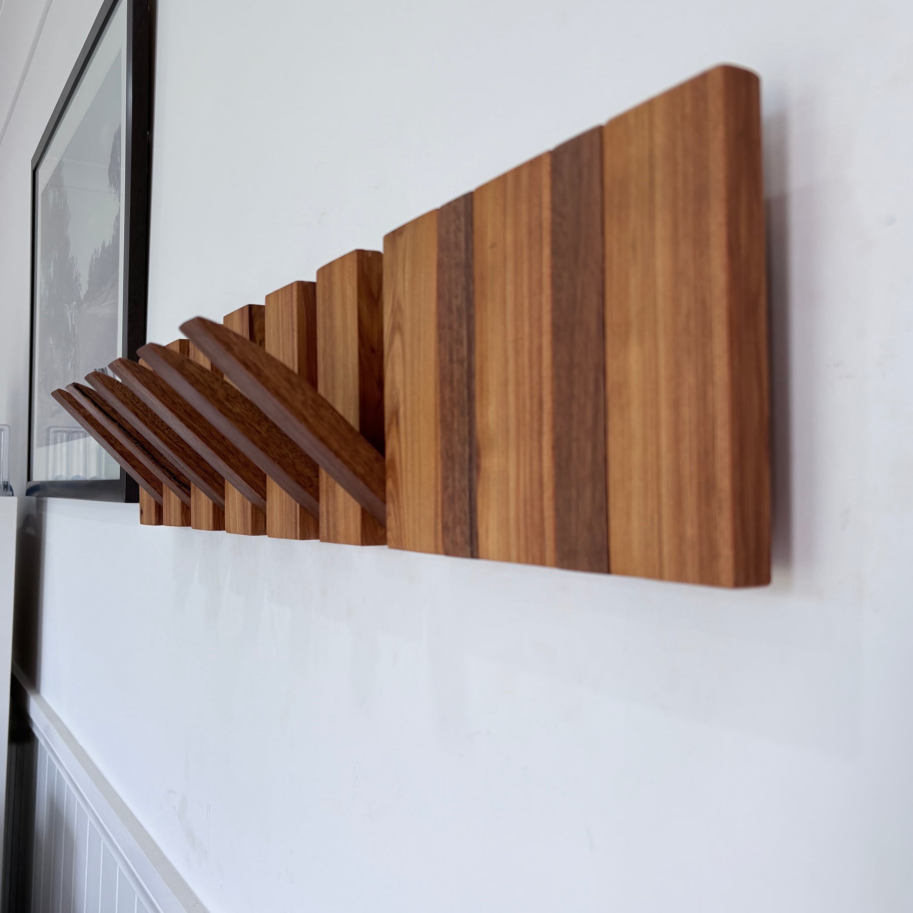 Two tone spotted gum and cypress horizon line piano style coatrack