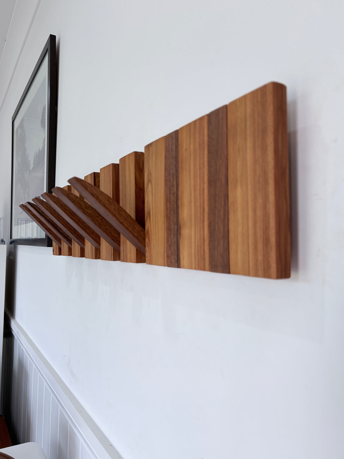 Two tone spotted gum and cypress horizon line piano style coatrack