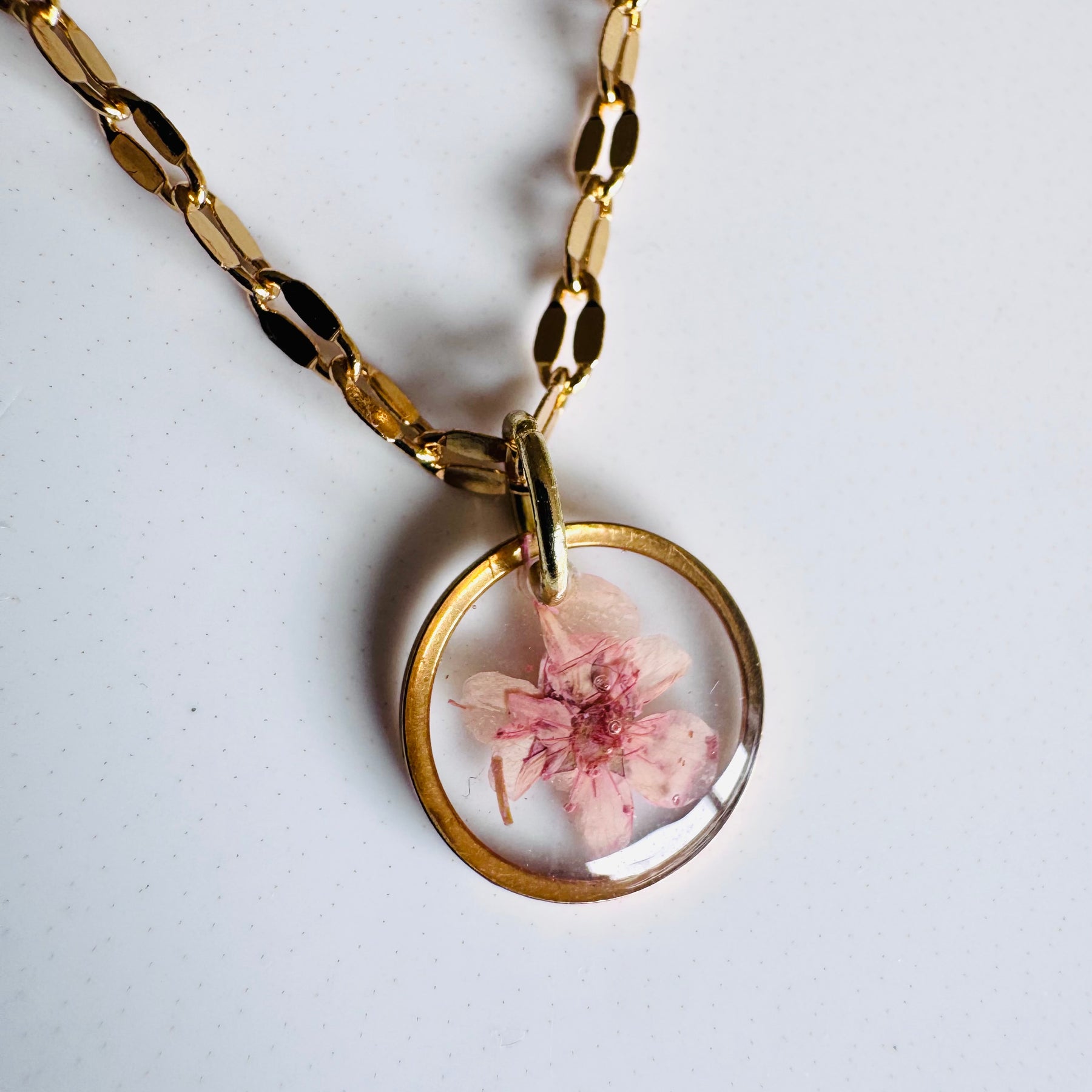 Gold plated resin necklace with pink wildflower