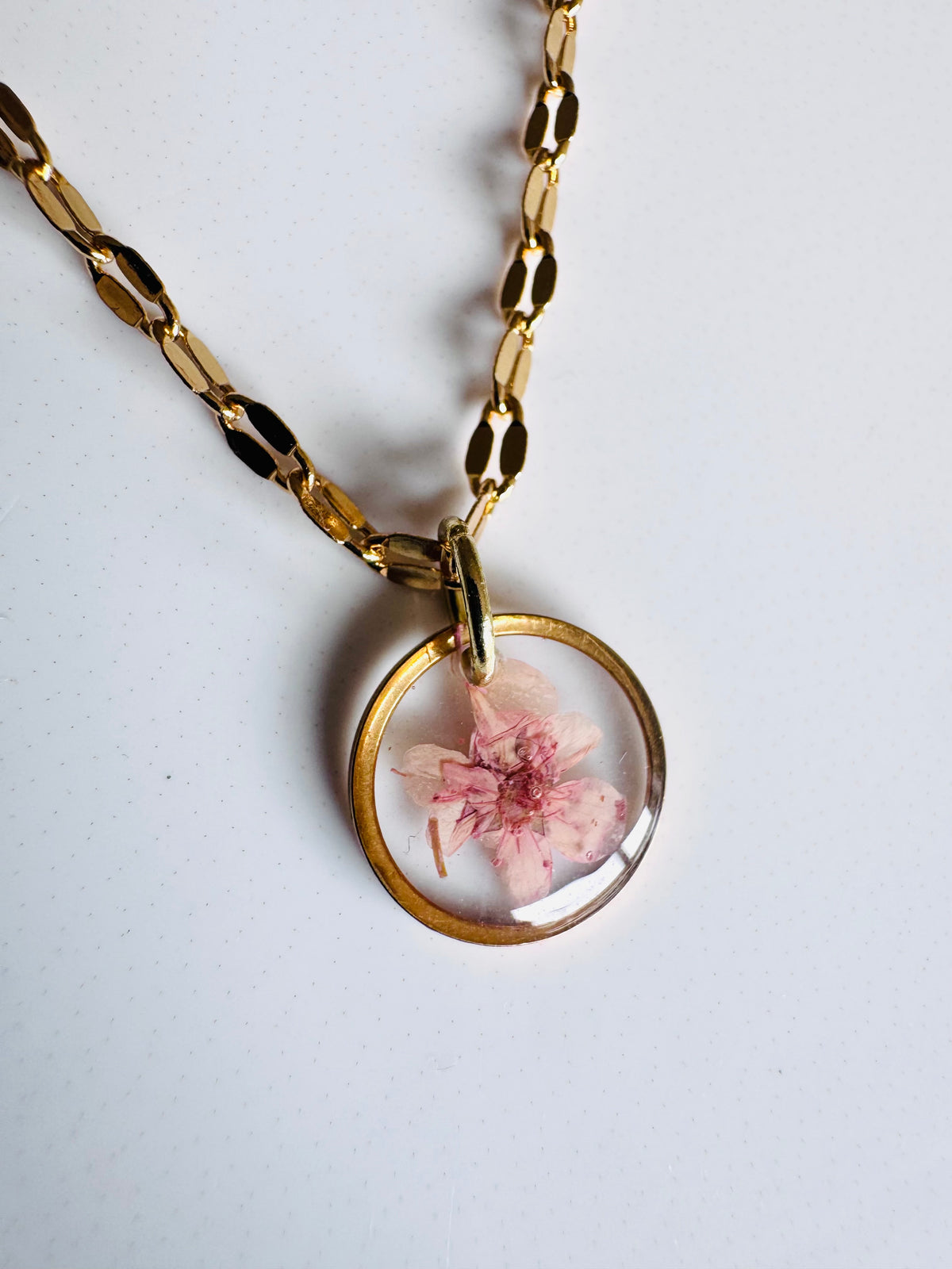 Gold plated resin necklace with pink wildflower