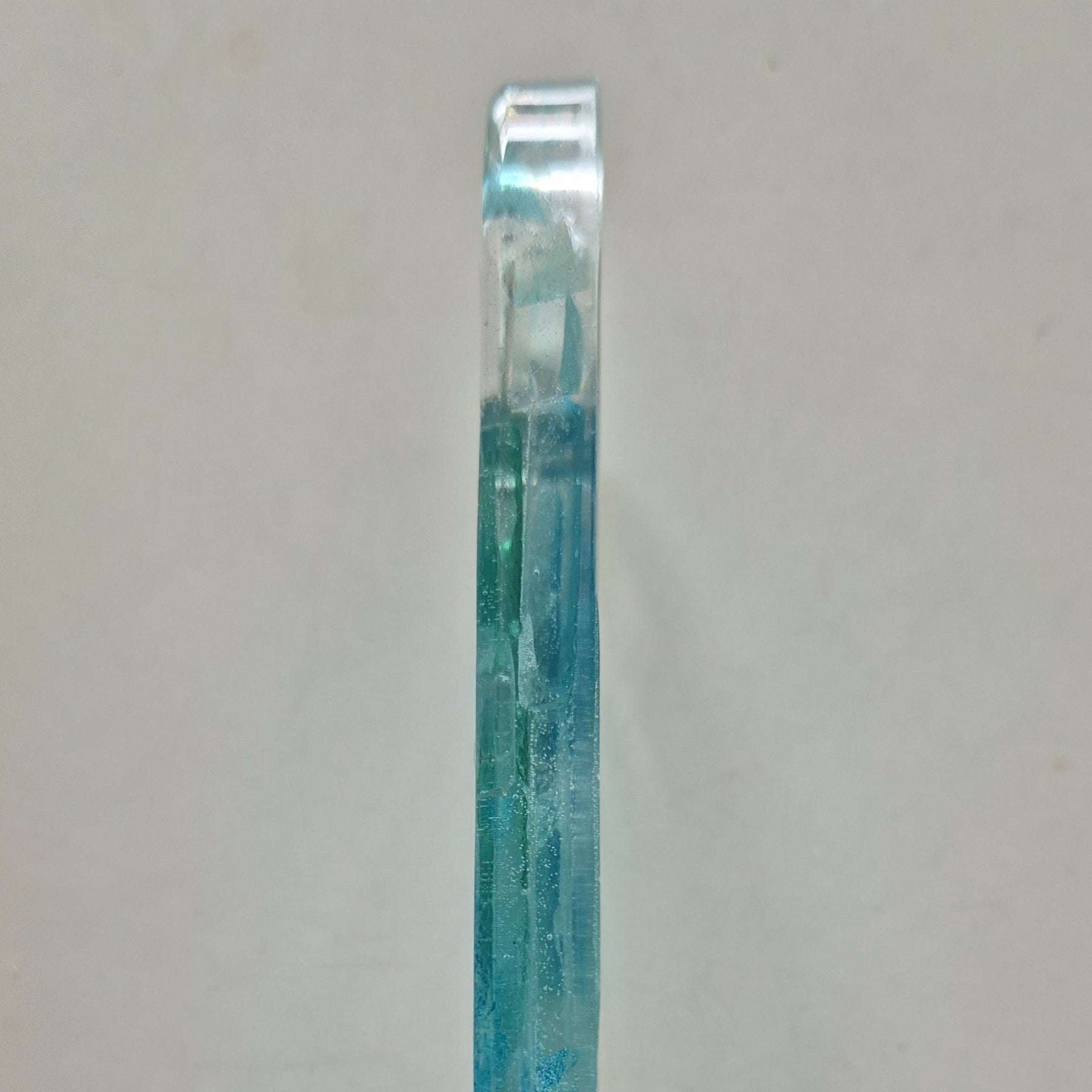 Resin bottle opener with inlaid sea glass