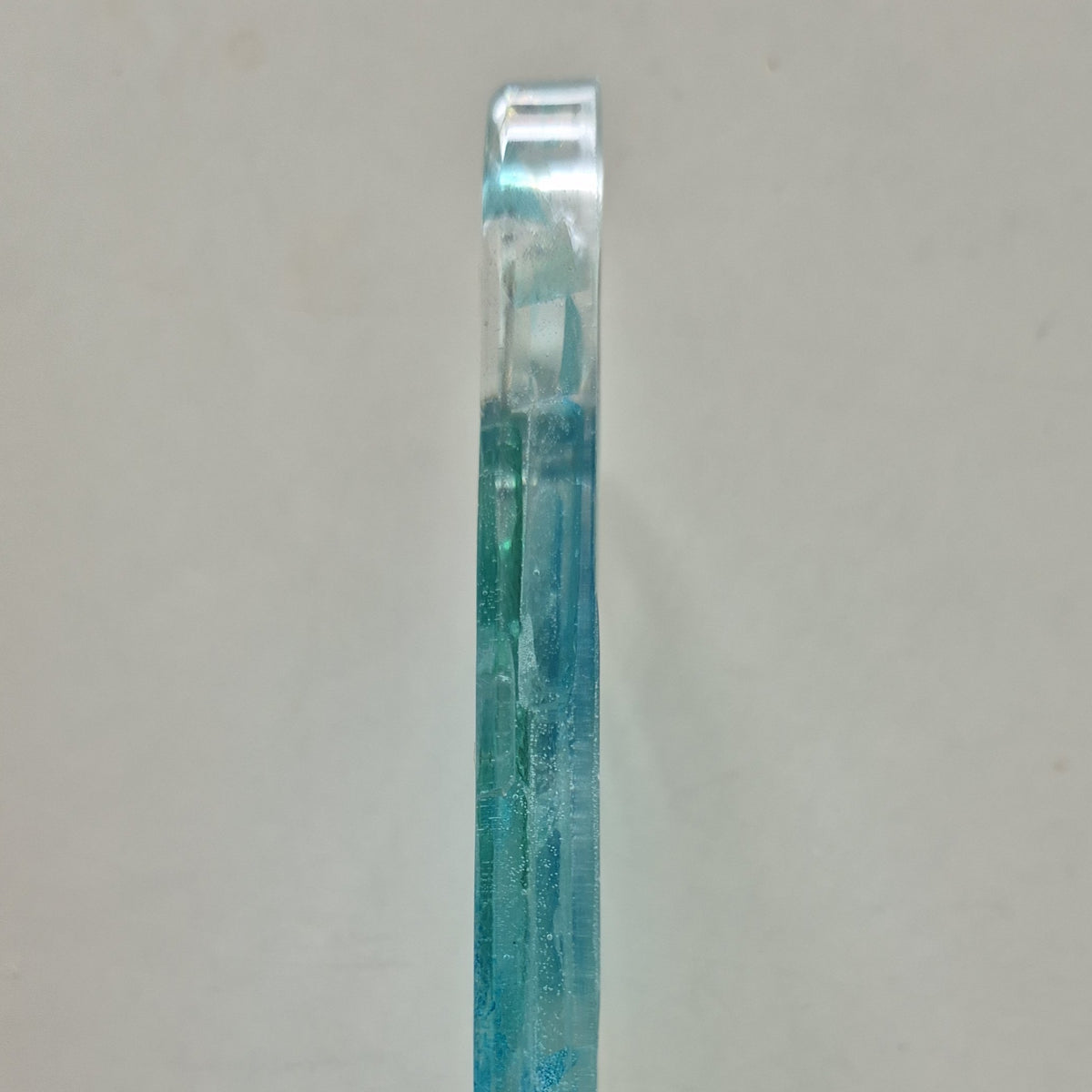 Resin bottle opener with inlaid sea glass